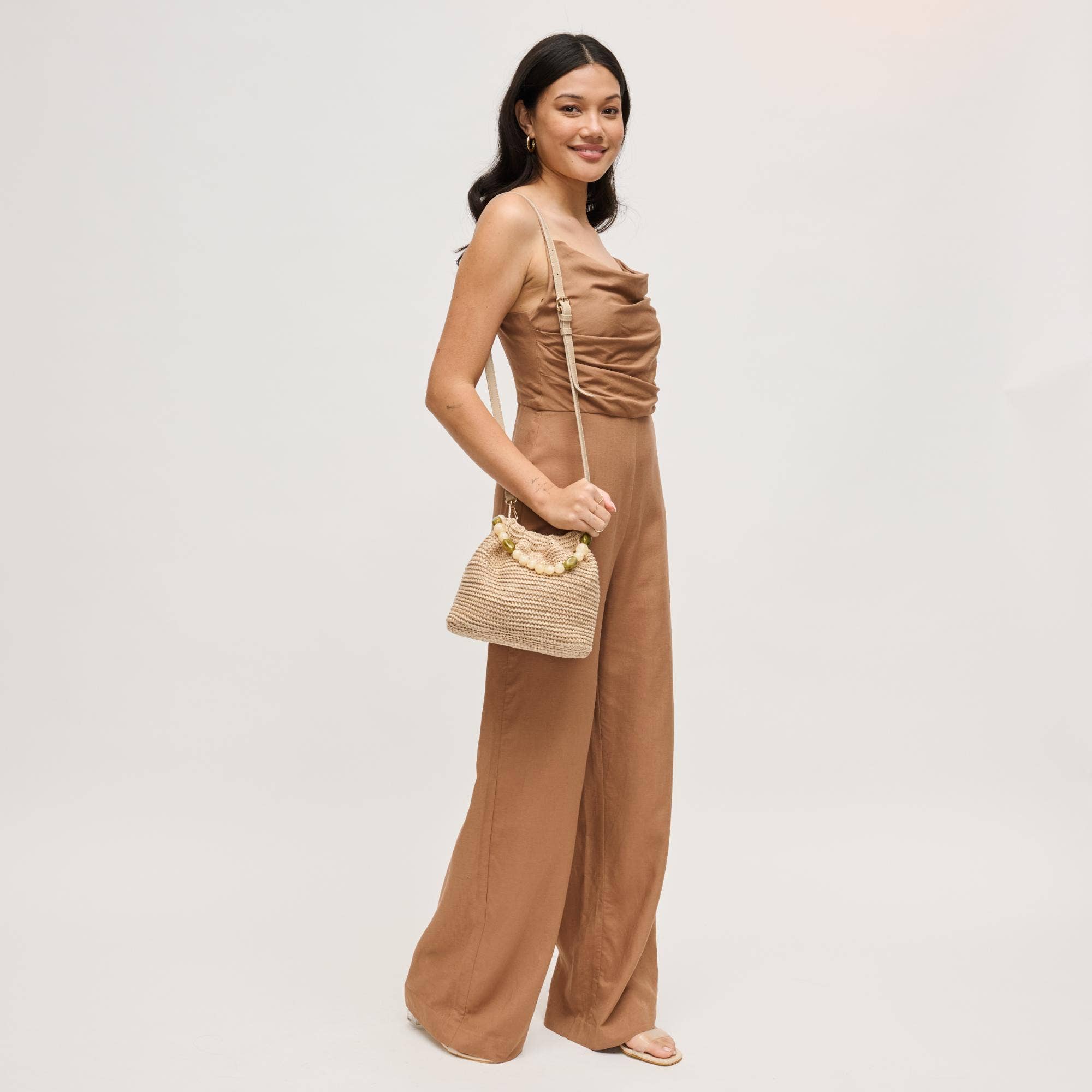 Urban Expressions Emery Crossbody bag with adjustable strap and zip closure, showcasing its sleek design and textured material.