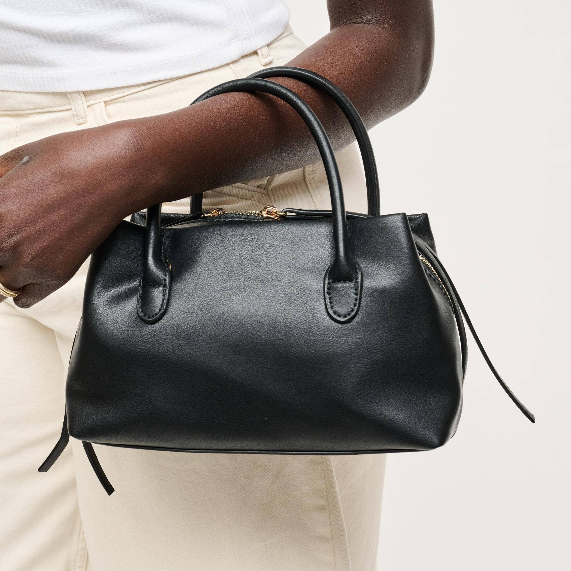 Urban Expressions Logan Crossbody bag in stylish design, showcasing adjustable strap and sleek exterior detail.