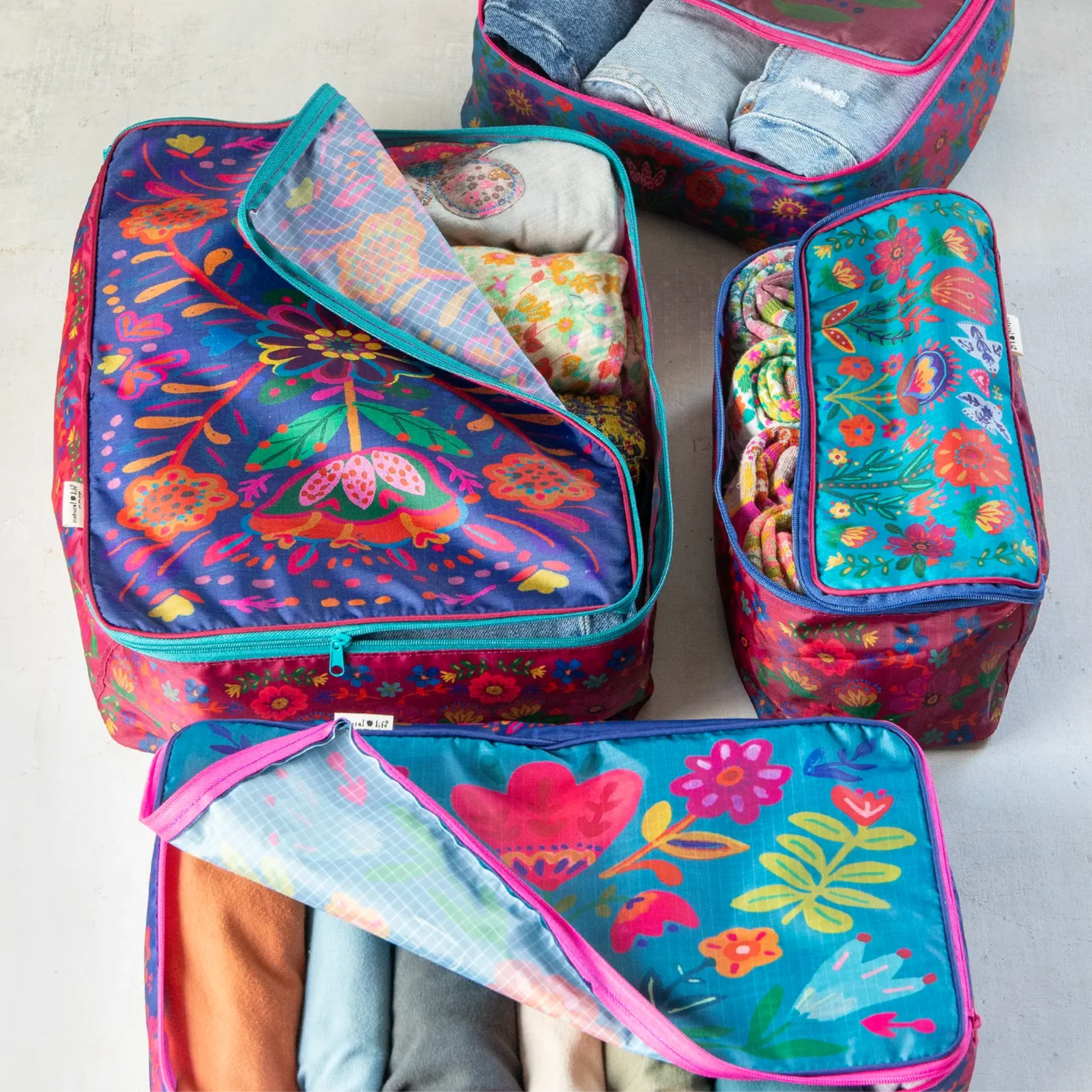 Set of 4 Natural Life travel packing cubes featuring a colorful multi folk flower design.