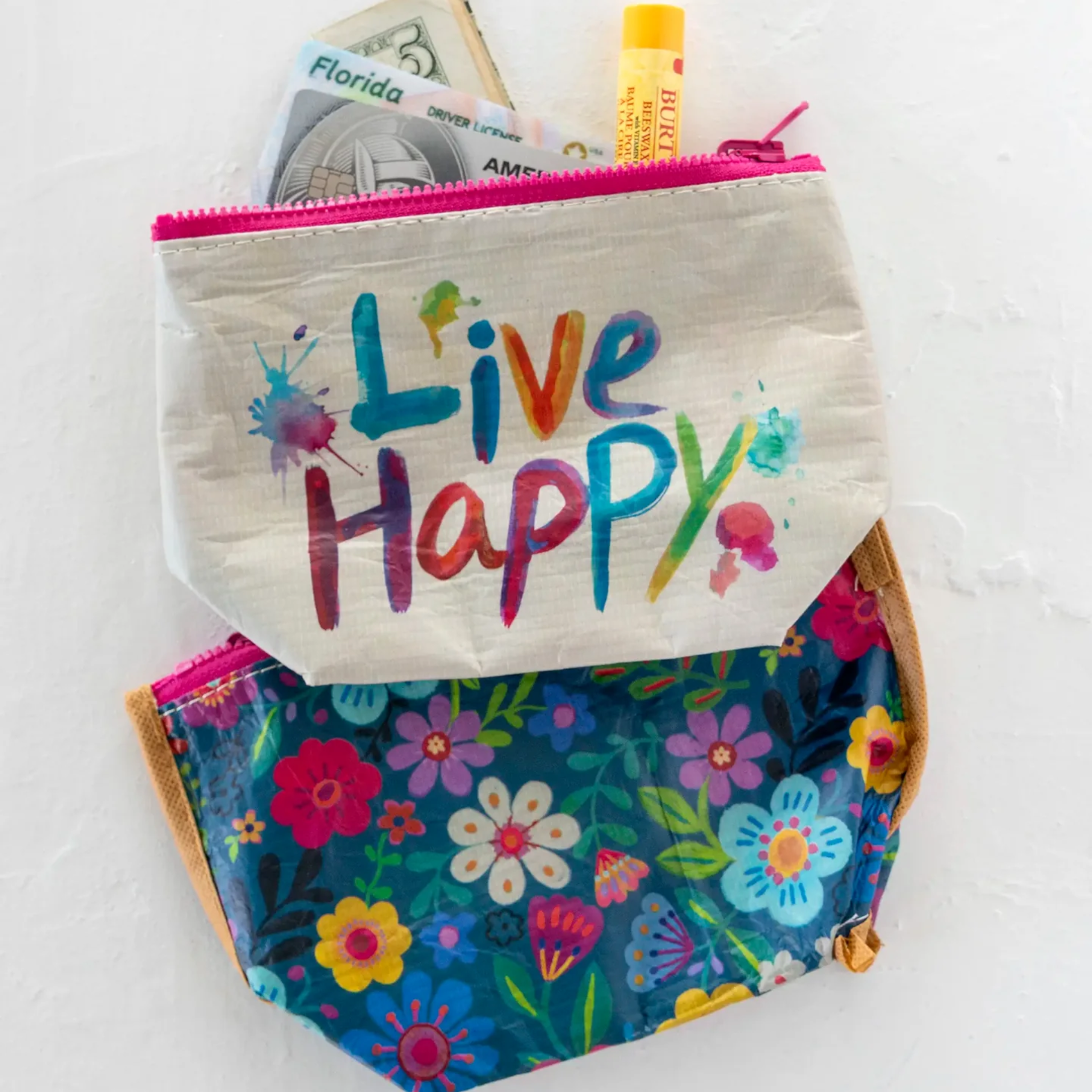 Small recycled reversible zipper pouch by Natural Life, featuring colorful patterns and a compact design for travel.