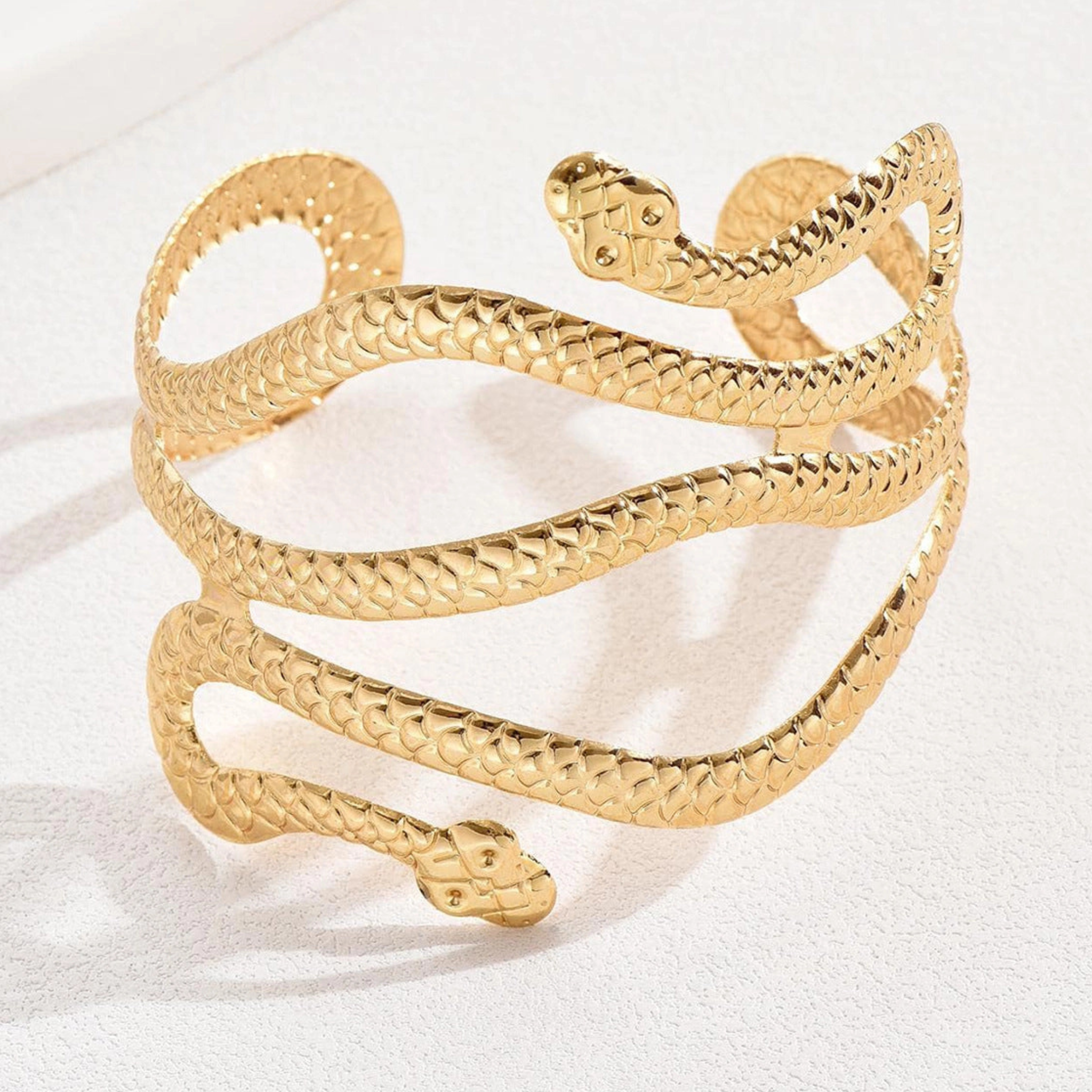 Private label snake wrap arm cuff bracelet featuring a sleek, coiled snake design on a stylish metal band.