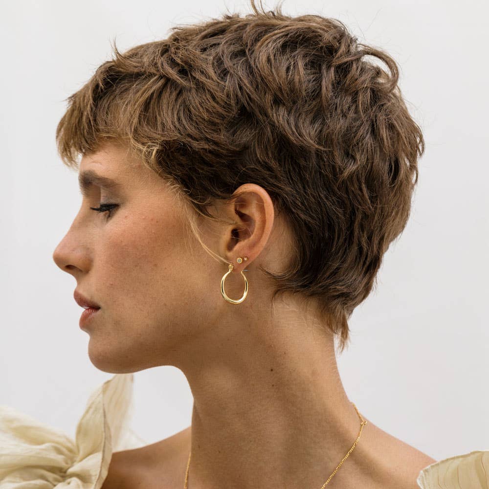 Small Maria hoop earrings by Amano Studio featuring delicate circular gold hoops for a minimalist jewelry look.