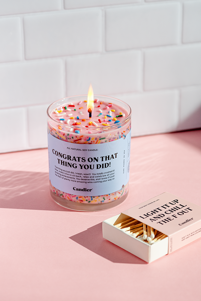 Candier congratulatory candle with "Congrats" message in elegant design, perfect for celebrations and special occasions.