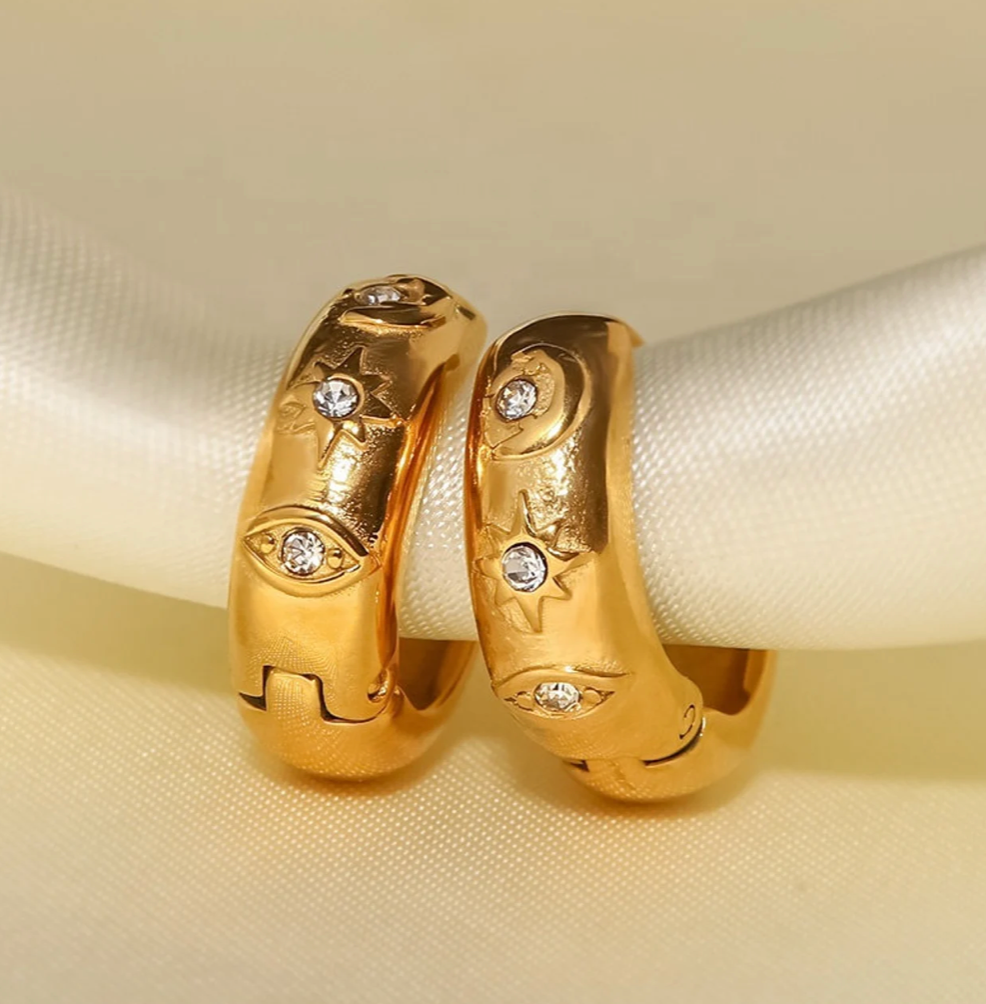 Chubby hoop earring featuring an evil eye design with CZ stones, crafted in 18K gold, waterproof PVD finish.