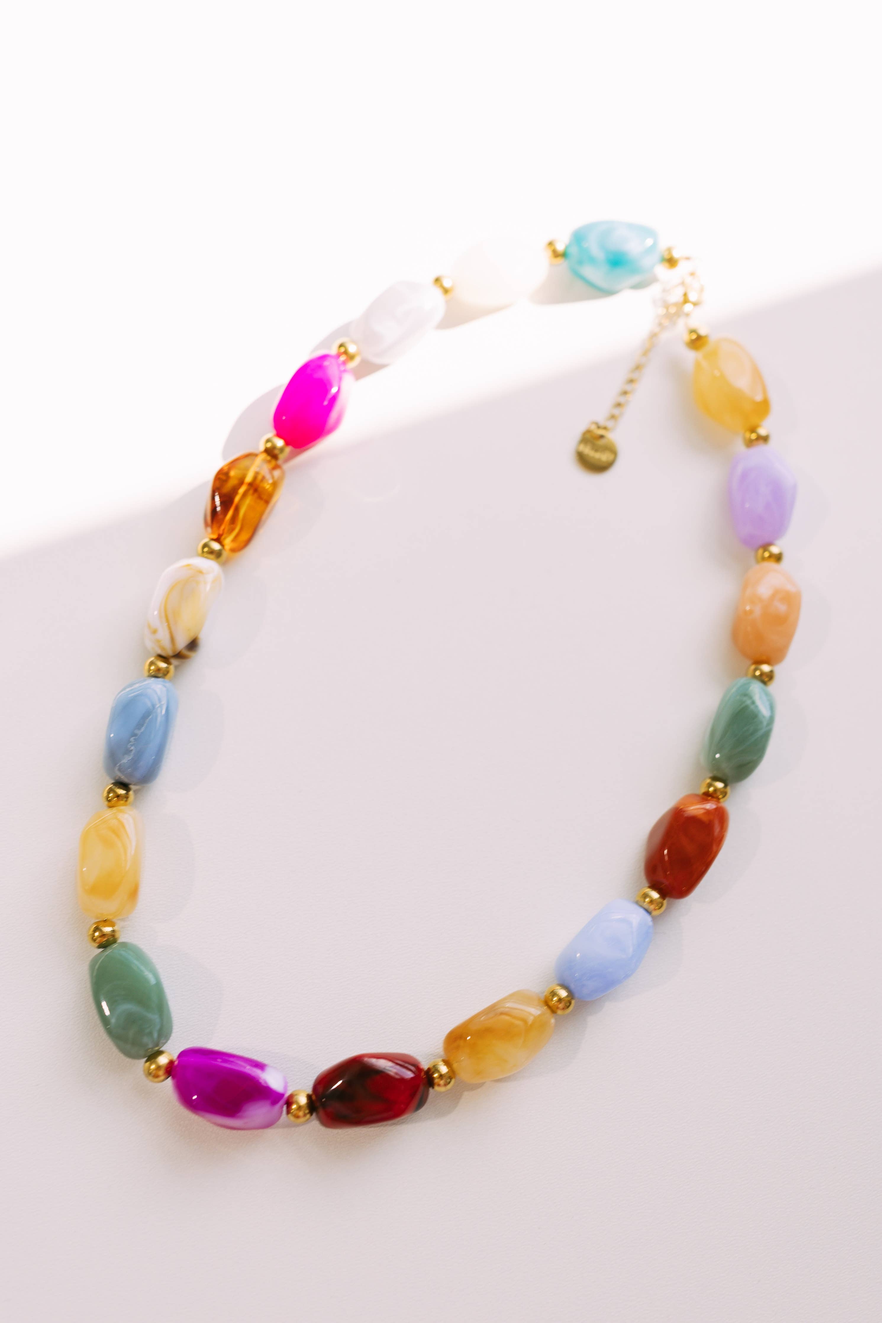 Color Lover Stone Necklace by BELJOY featuring colorful stones on a delicate chain against a neutral background.