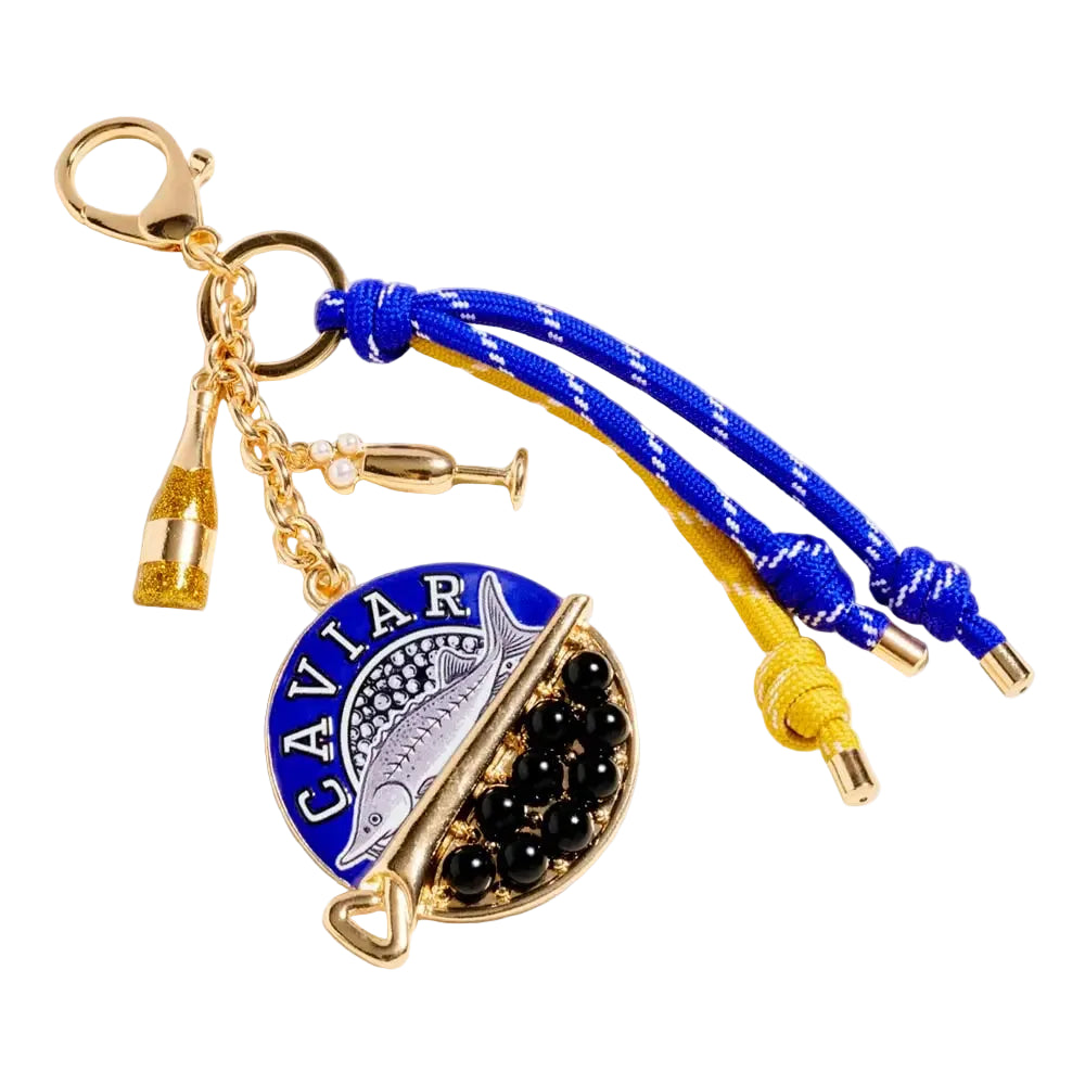Caviar sardine champagne glass charm with knotted rope detail, designed as a stylish bag charm and keychain accessory.