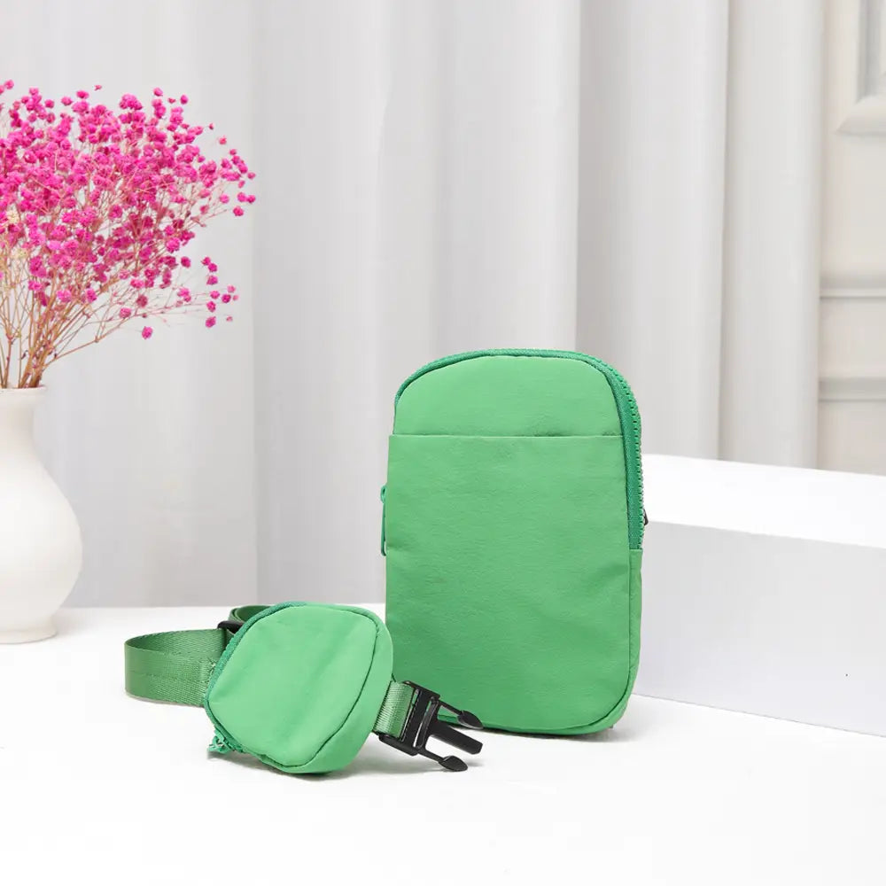 Green nylon sling bag from private label, stylish crossbody bag with sleek design and adjustable strap.
