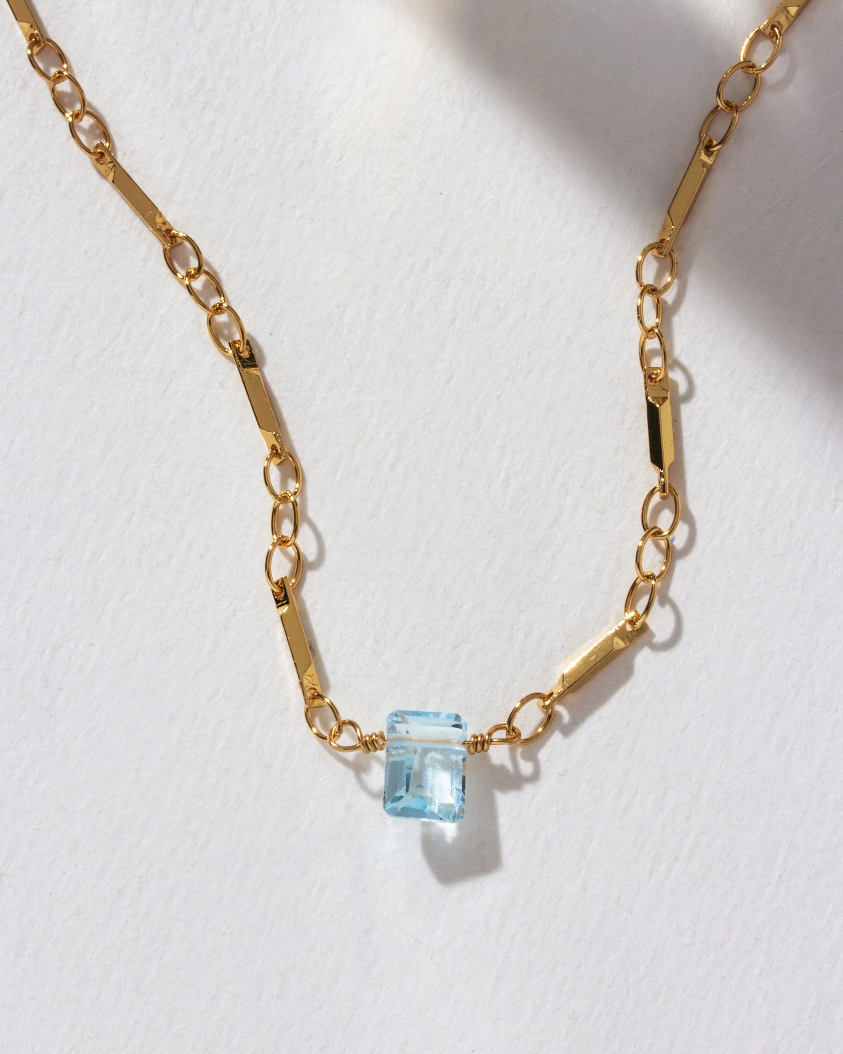 Luna Norte Prism Gems December birthstone necklace featuring a sparkling gemstone and delicate chain on a white background.