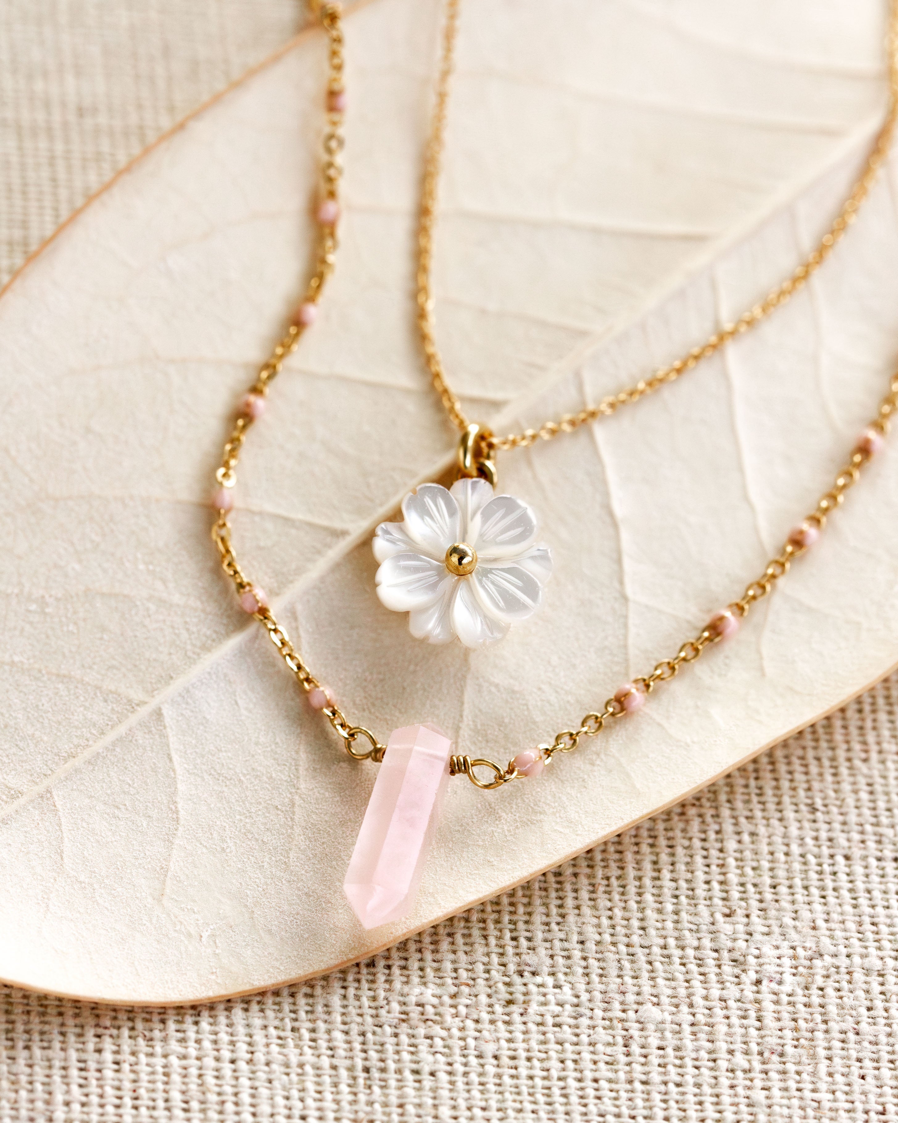 Luna Norte Blooming Crystal layered necklace set with rose quartz pendants and delicate chain details.