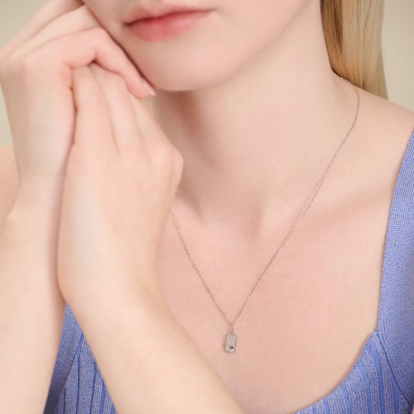 M by Monte Luna Mini-Heart Tag Pendant Necklace featuring a small silver heart-shaped pendant on a delicate chain