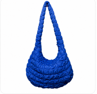 Large quilted puffer crossbody handbag by private label, featuring a padded design and adjustable strap for convenient carrying.