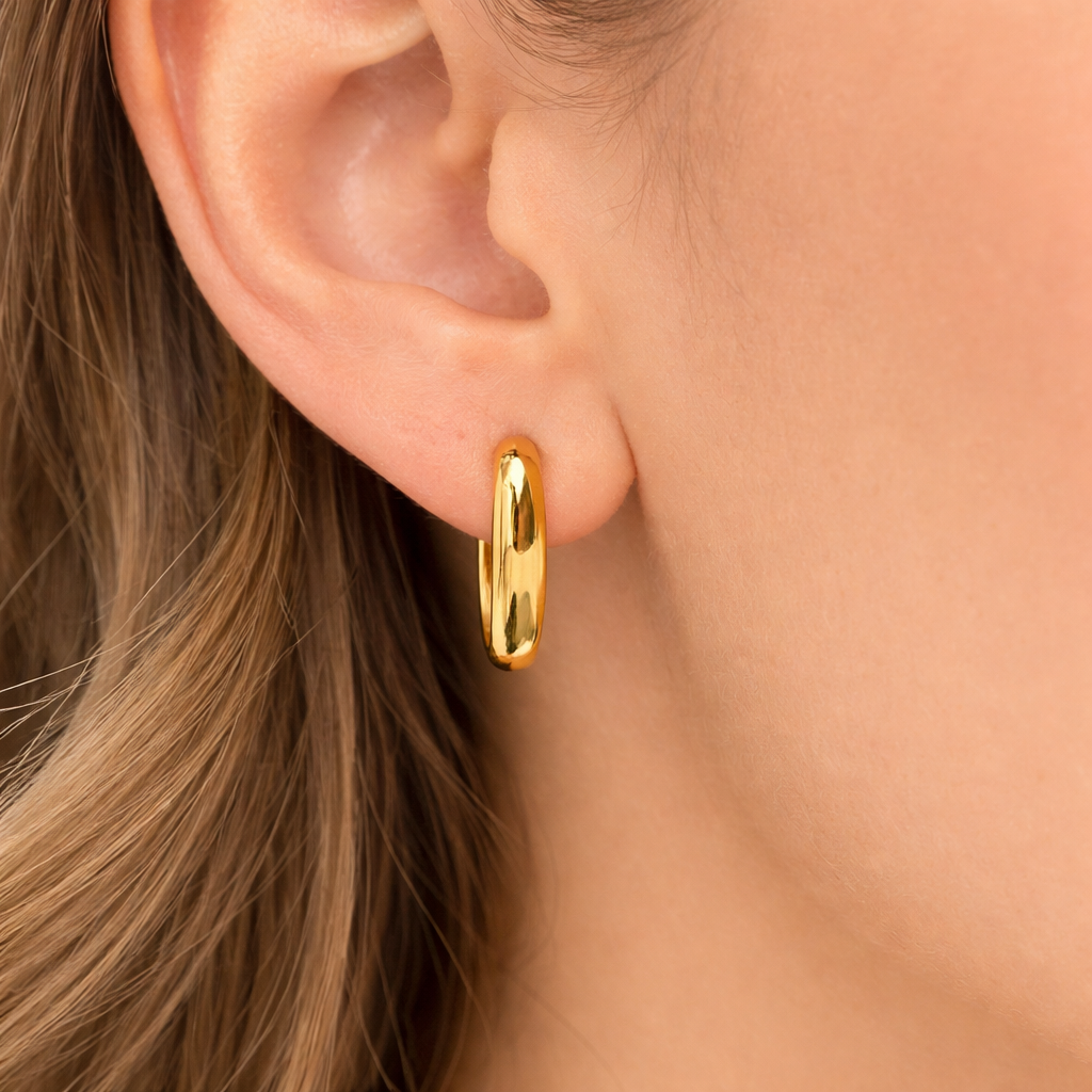 Gold cutout oval hoop earrings by Private Label Jewelry, featuring a stylish oval shape with a polished finish.