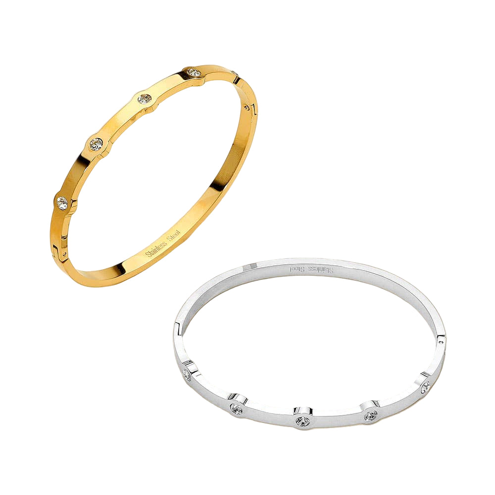 Gold and silver bracelets on a beige background