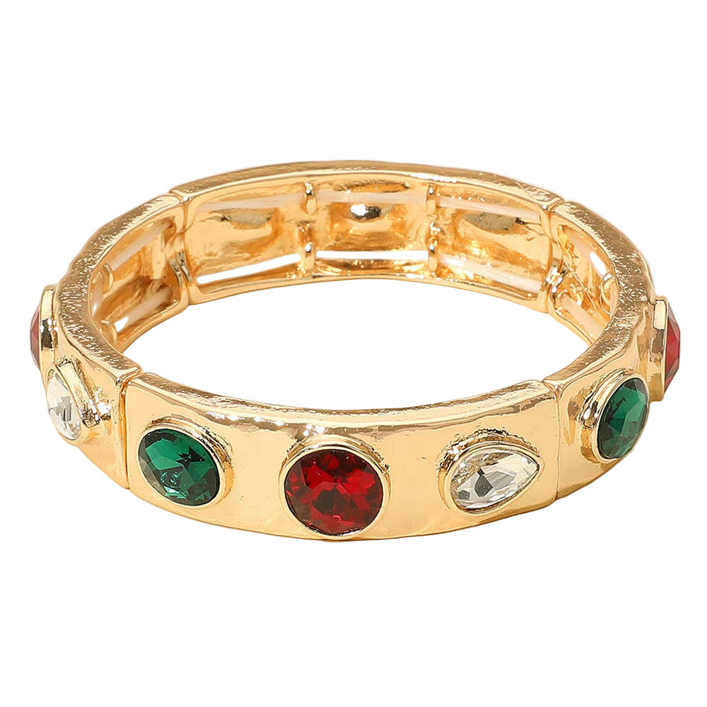 Gold bracelet with colored gemstones on a beige background