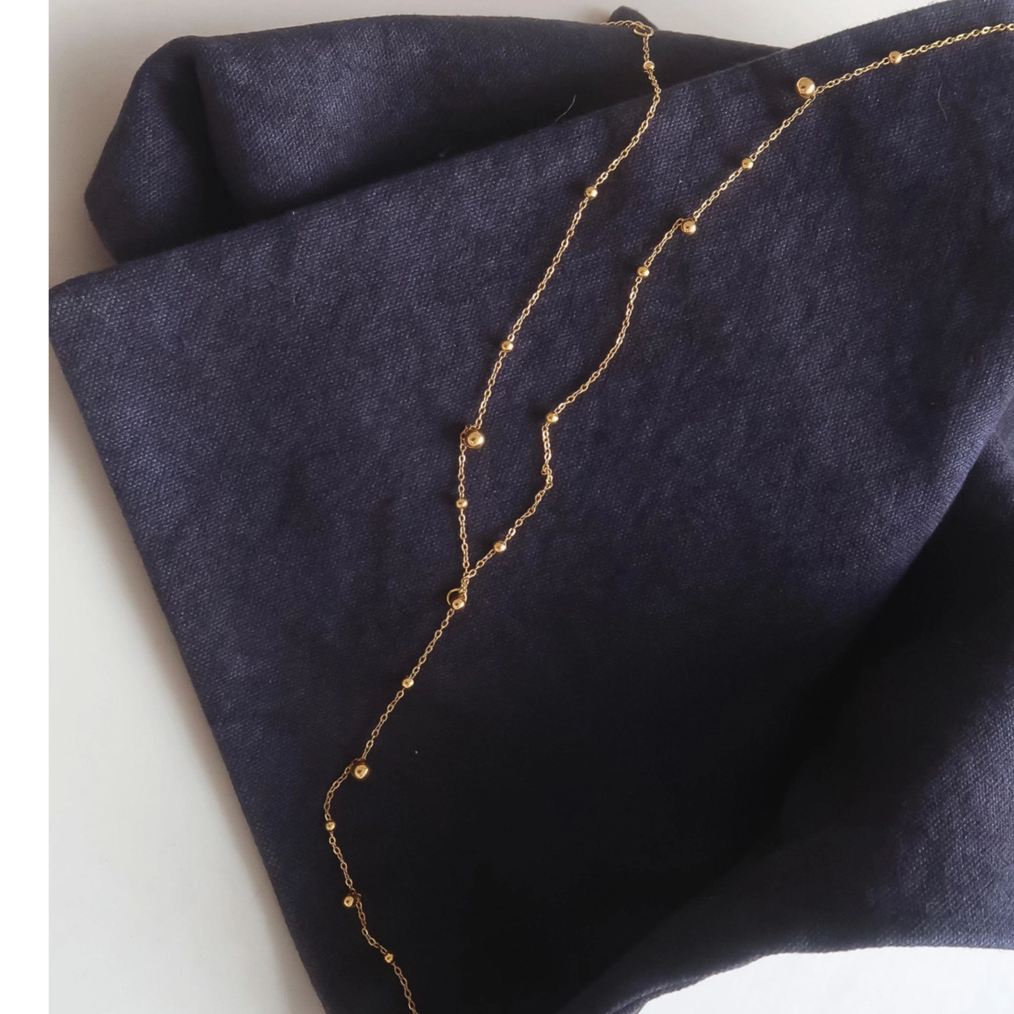 Private label Brisse 18K gold non-tarnish beaded Y lariat necklace with elegant design and intricate beading detail.