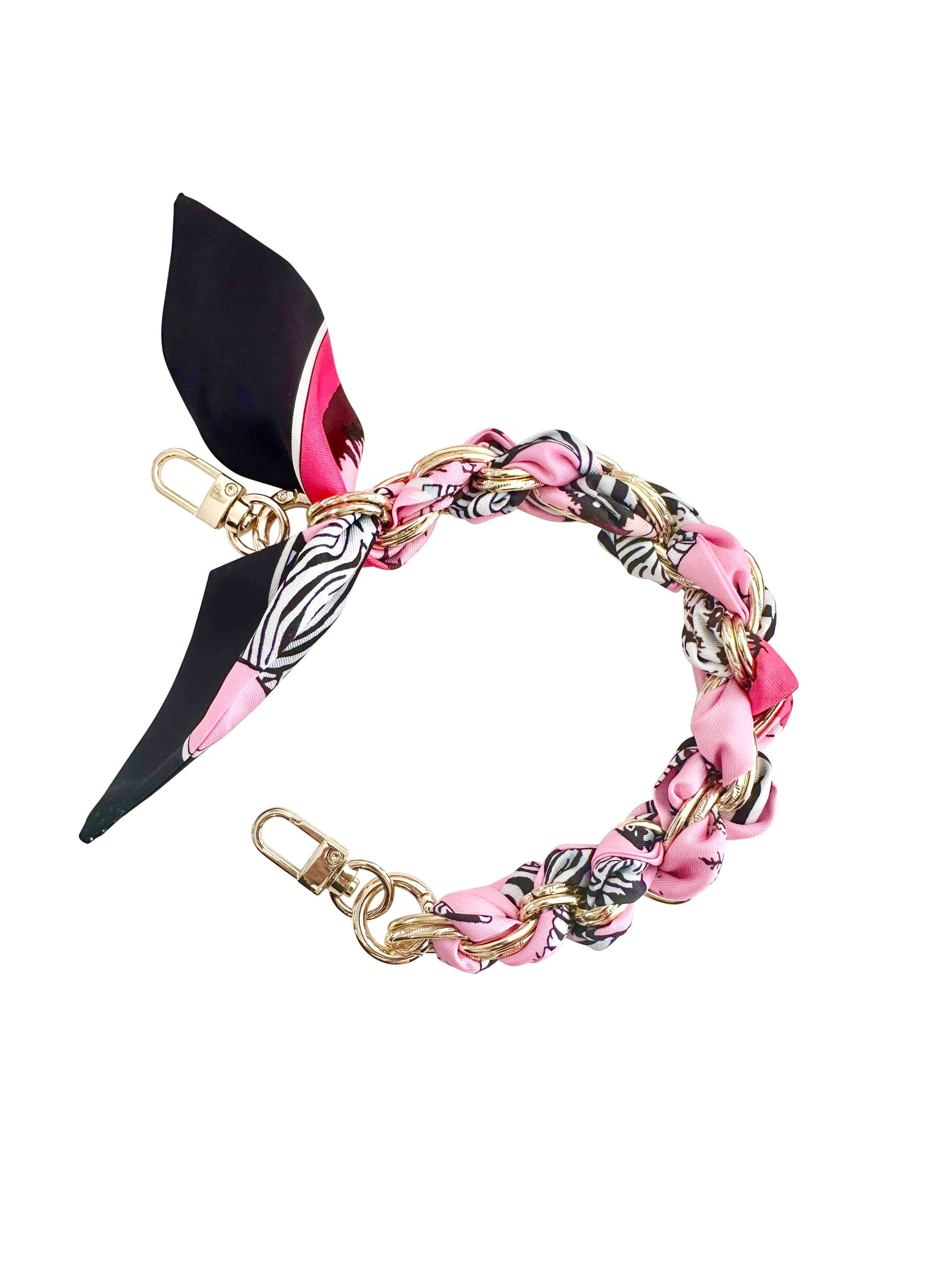 Gold phone chain featuring a pink zebra print design by Gemelli, showcasing a stylish and trendy accessory.