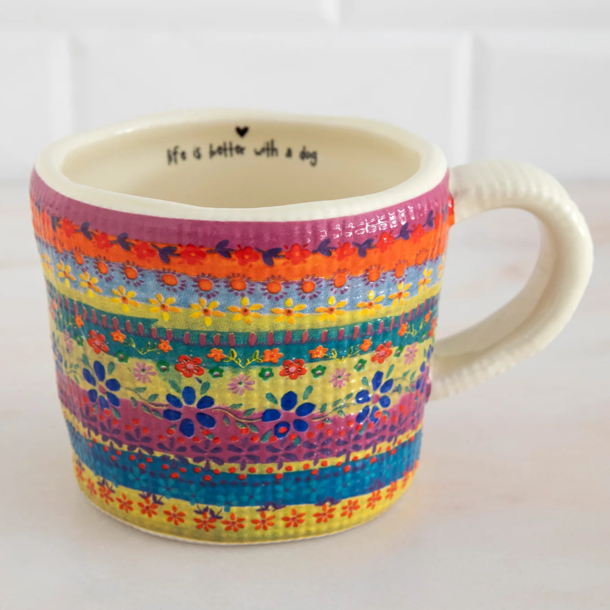 Natural Life Peek-A-Boo Coffee Mug featuring a playful dog design against a colorful background.