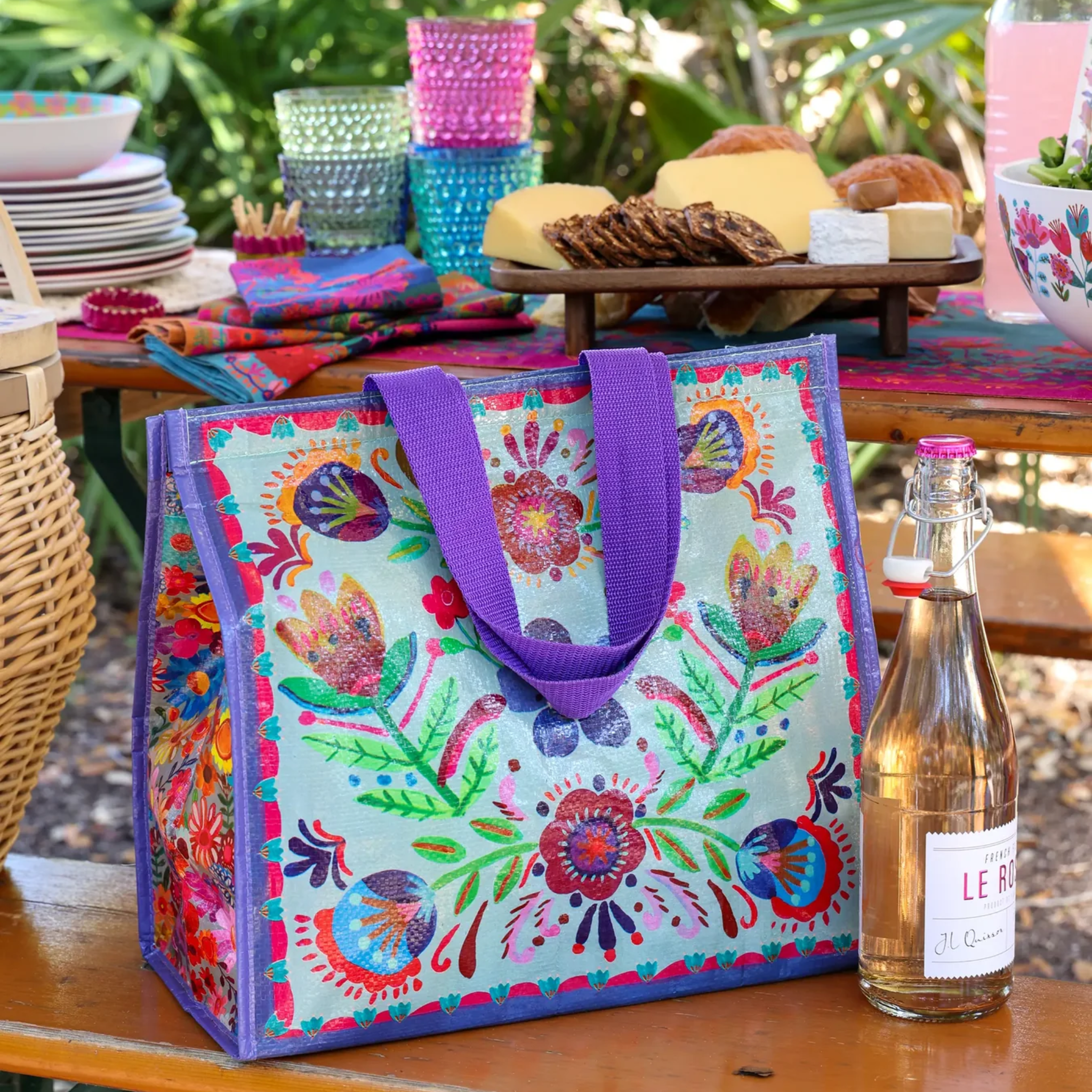 Dusty blue insulated cooler tote with a folk flower pattern by Natural Life, showcasing the design and functionality.
