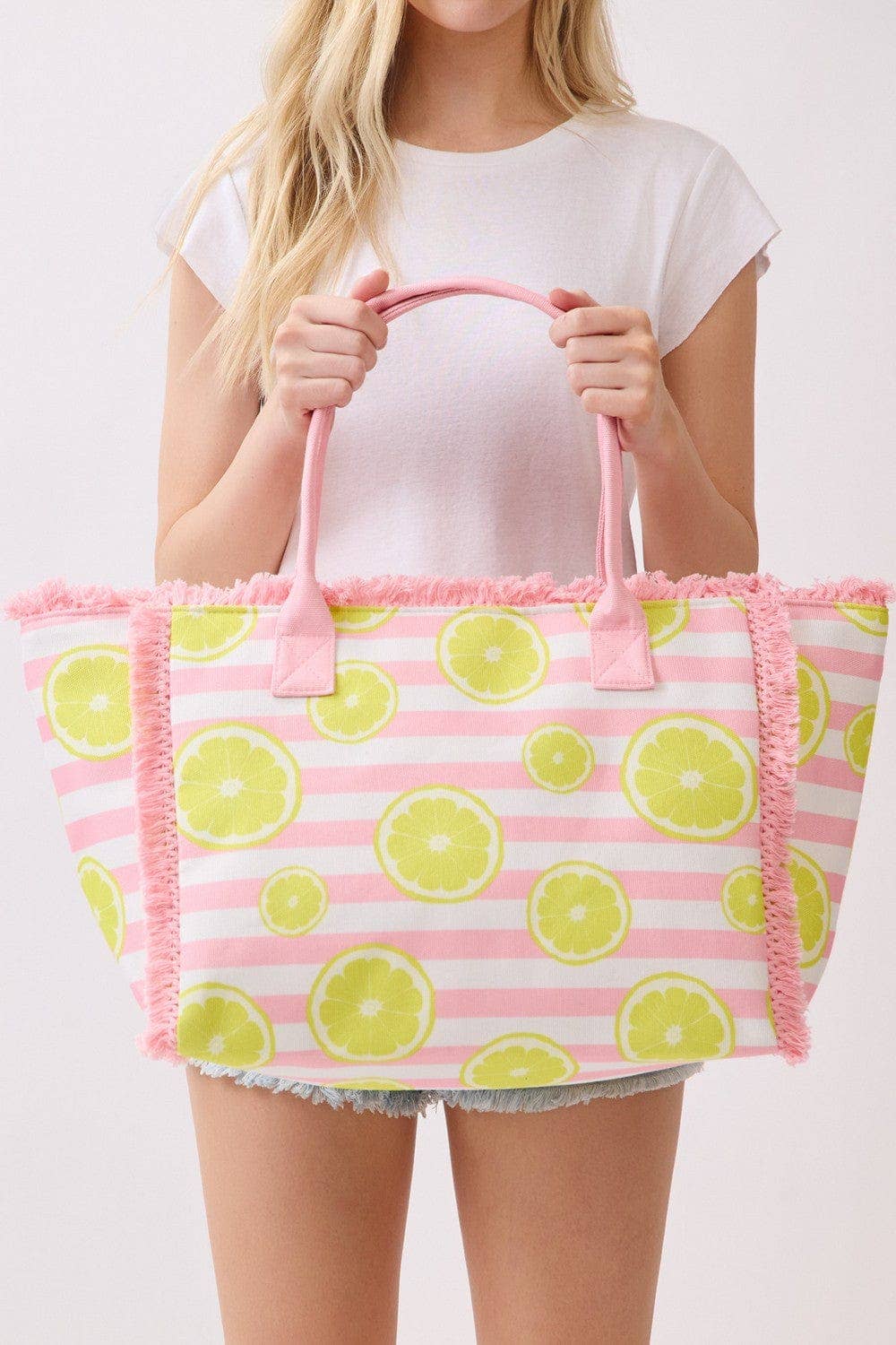 Lemon stripe fringe beach tote bag with a spacious interior and stylish design, perfect for summer outings.