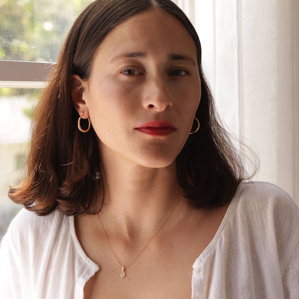 Small Maria hoop earrings by Amano Studio featuring delicate gold hoops with a smooth finish and minimalist design.