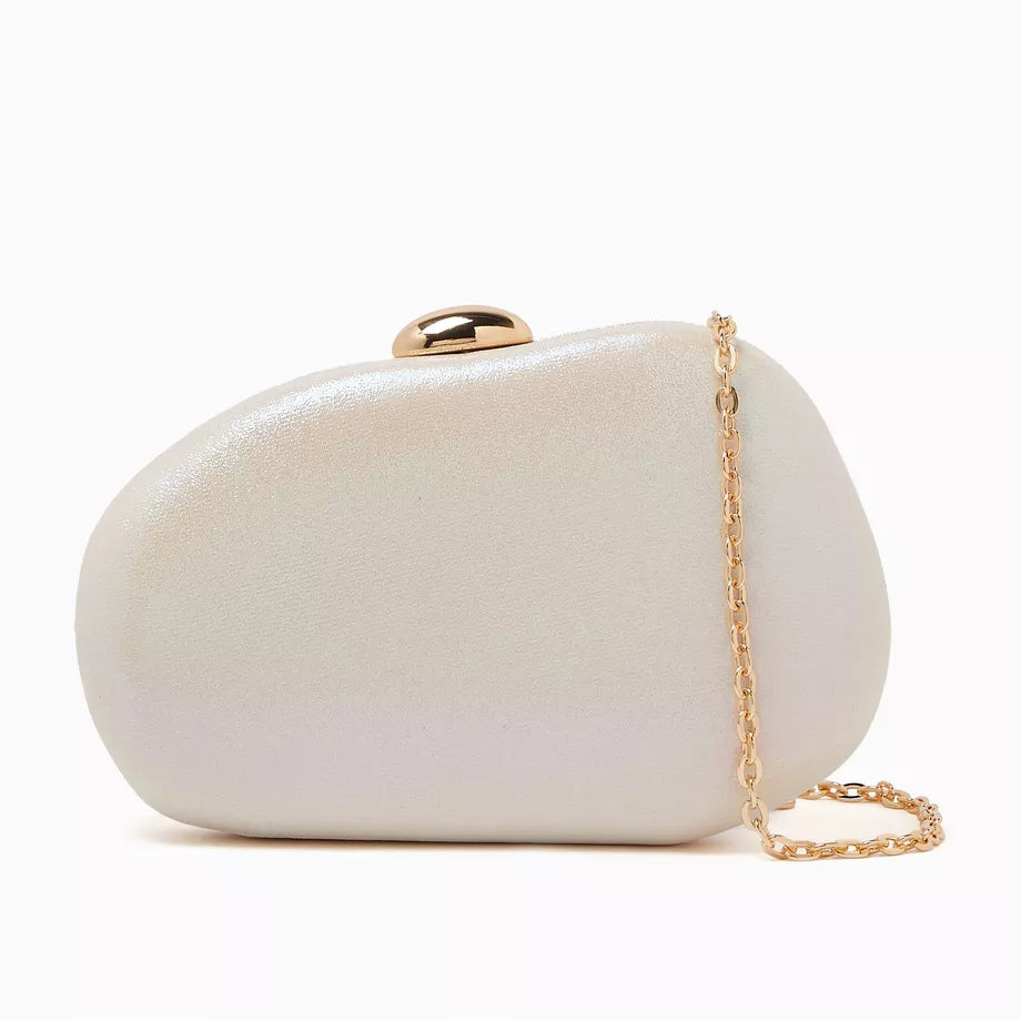 White Dolce Vita Dionne hardshell clutch with sleek design and silver clasp, perfect for elegant occasions.
