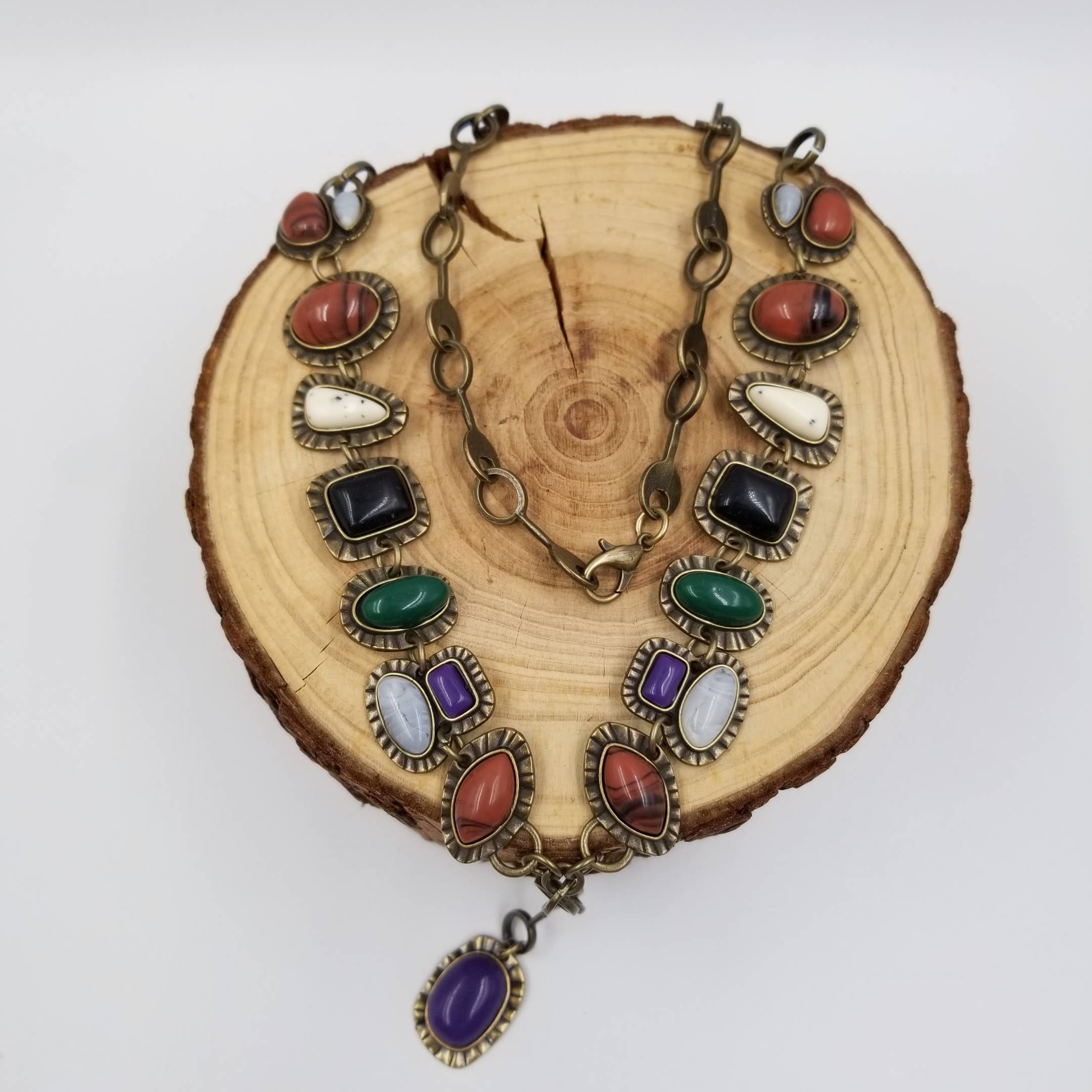 Necklace with colorful stones on a wooden surface