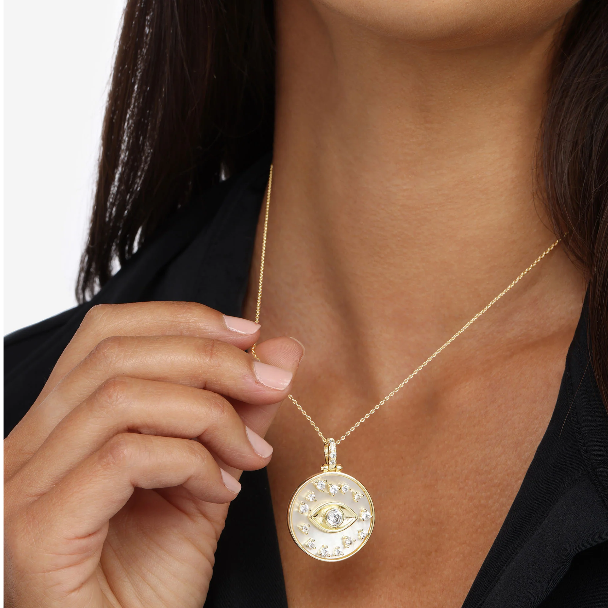 Gold Evil Eye Medallion Necklace by Melinda Maria adorned with white diamondettes, showcasing intricate detailing and elegance.