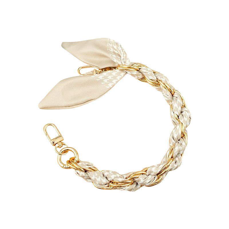 Gold phone chain by Gemelli featuring a cream and ivory houndstooth scarf design, ideal for stylish phone carrying.