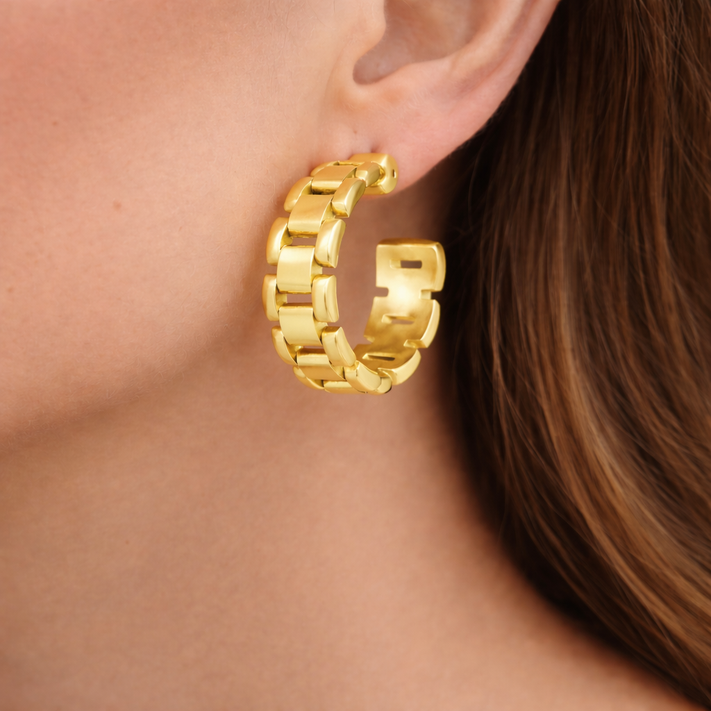 Sahira Jewelry Design Watch Link Hoop earrings featuring a unique linked design and polished metal finish.