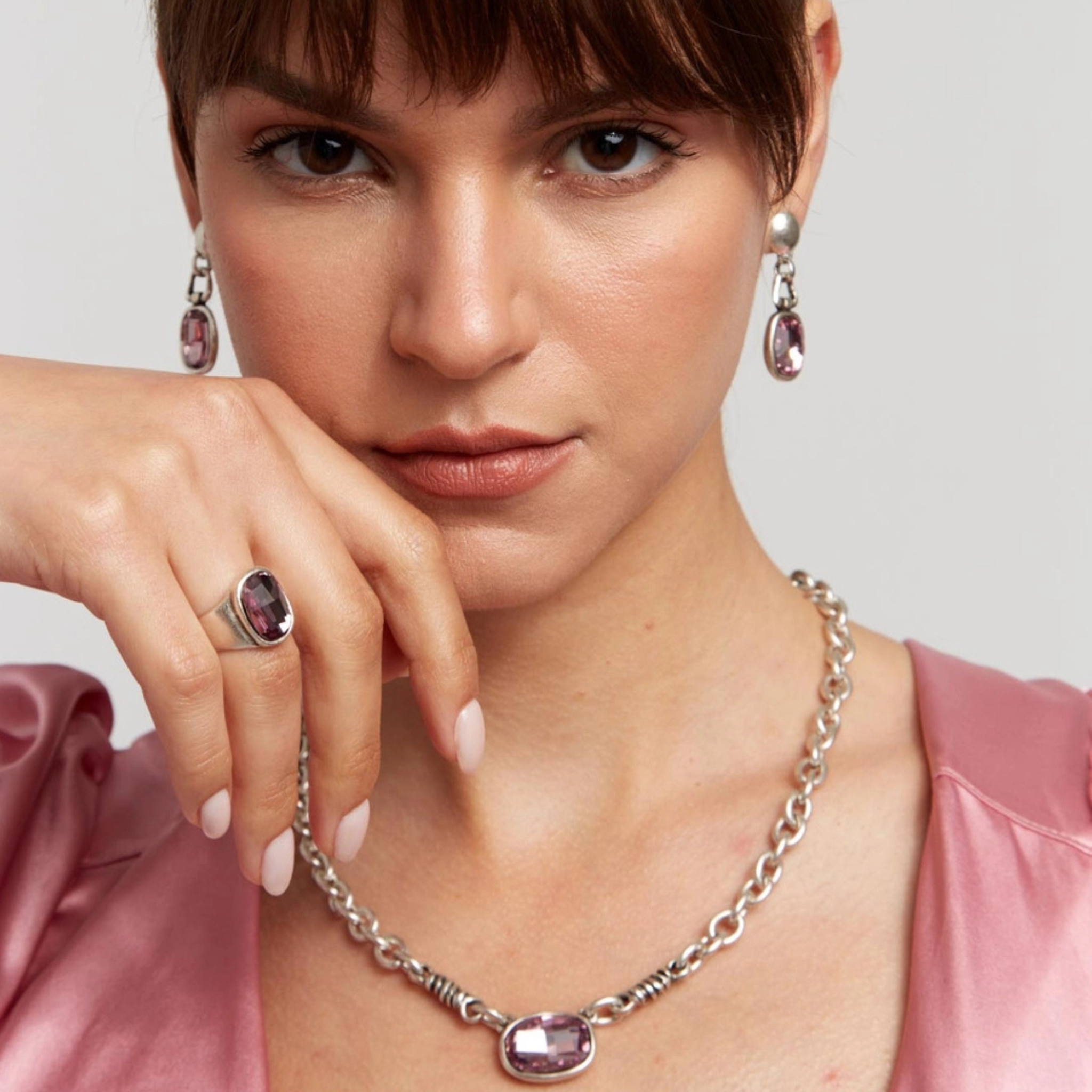 Handmade pink crystal pewter necklace by Chanour featuring a delicate pink crystal pendant and intricate pewter chain.
