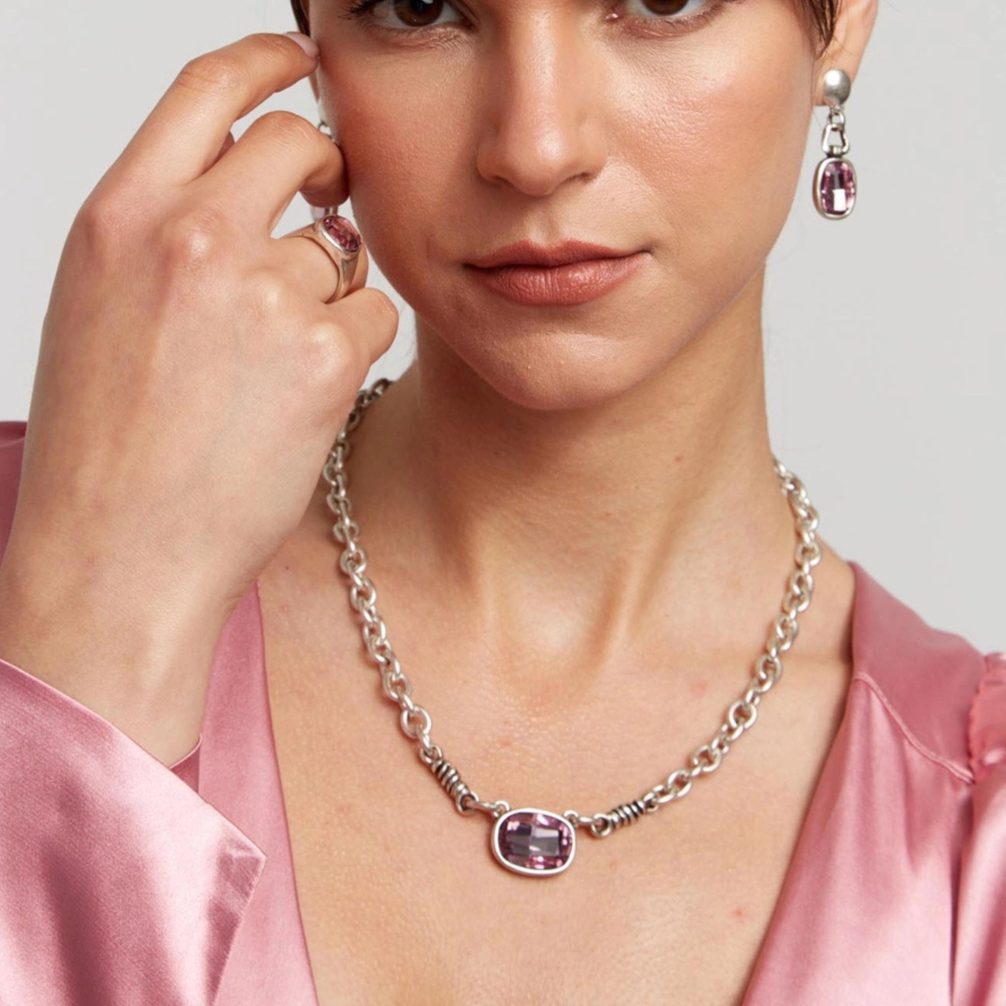 Handmade pink crystal pewter necklace featuring a delicate chain and shimmering pink gemstone pendant, crafted by Chanour.