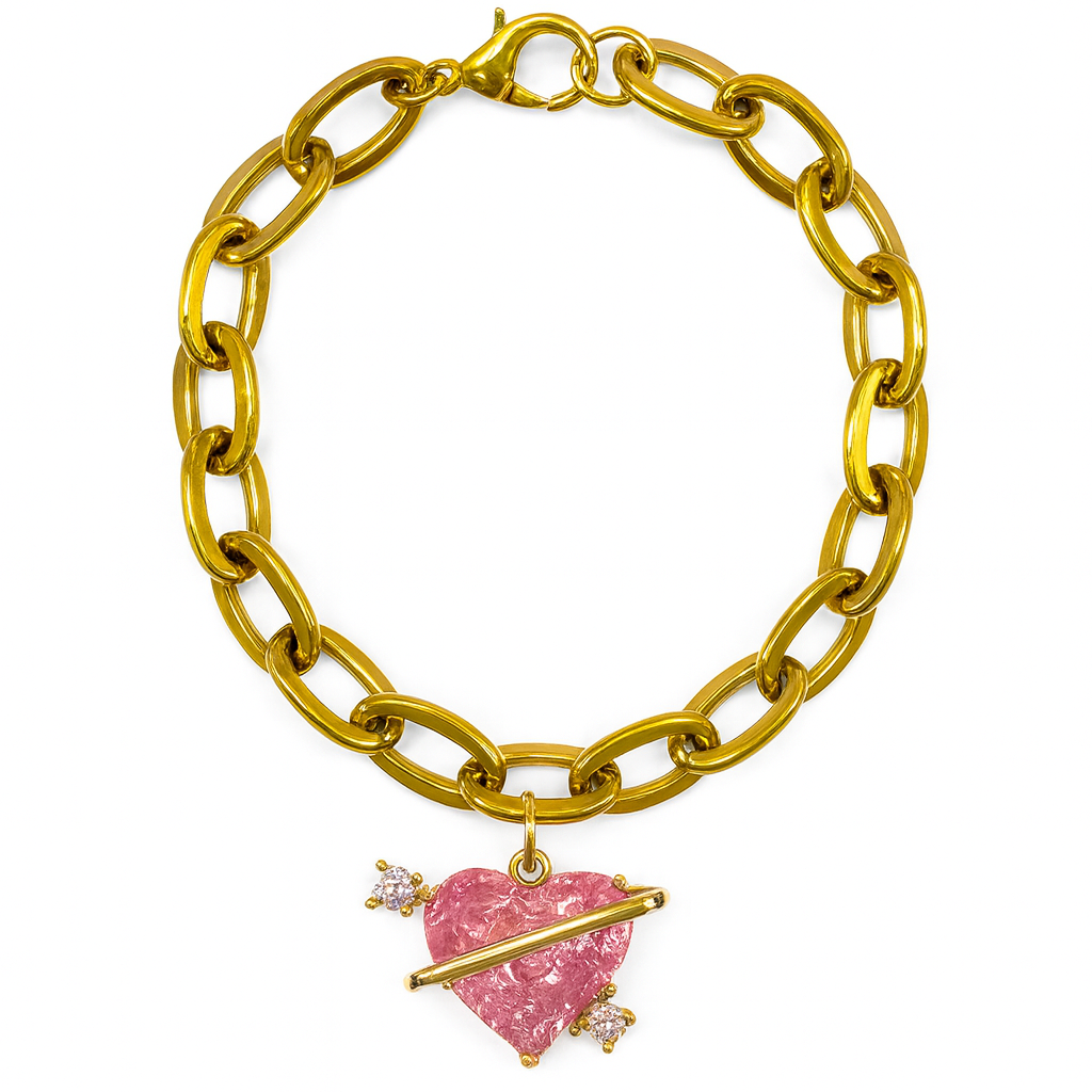 Gold chain bracelet with a pink heart and arrow charm on a white background