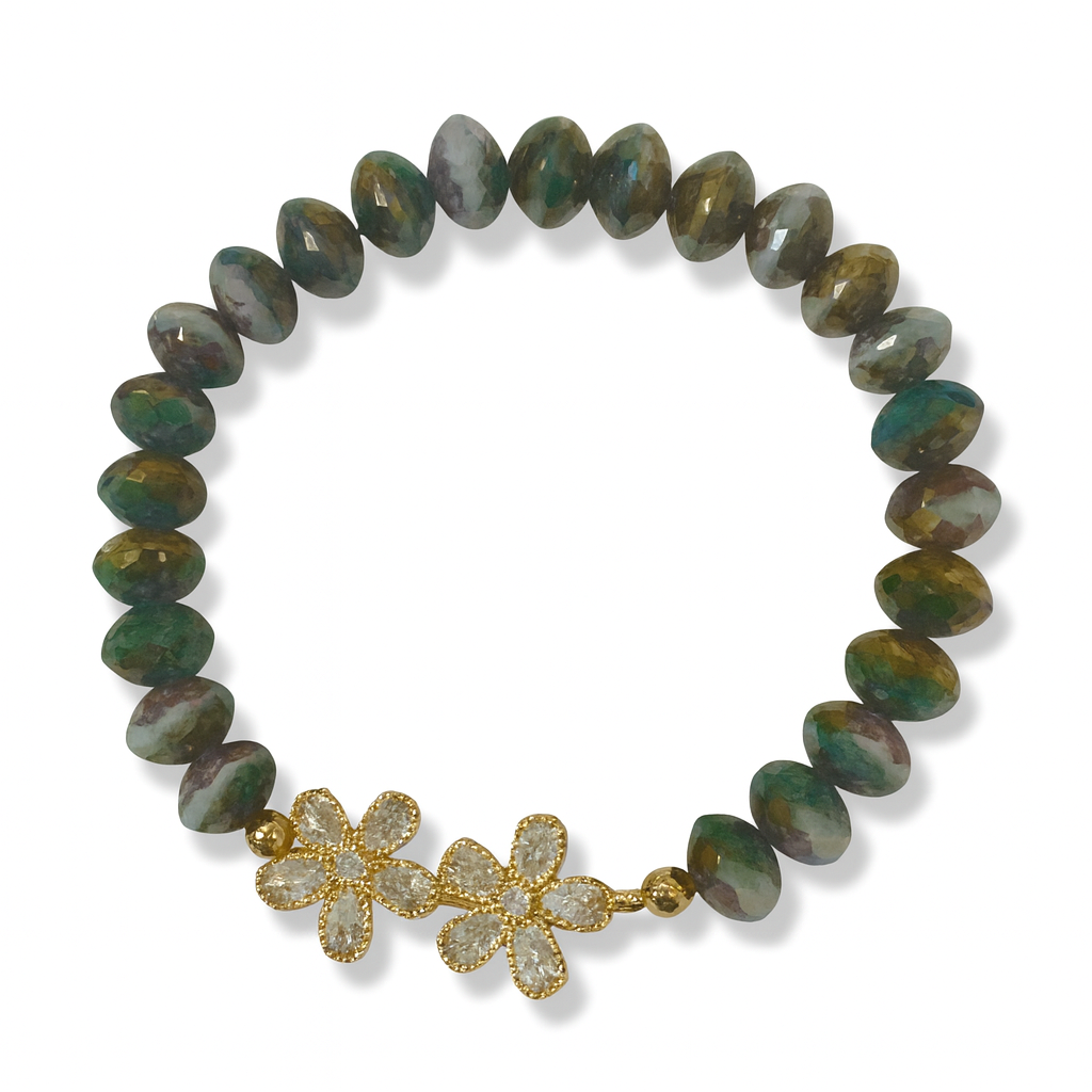 Bracelet with green beads and gold flower-shaped clasps on a white background