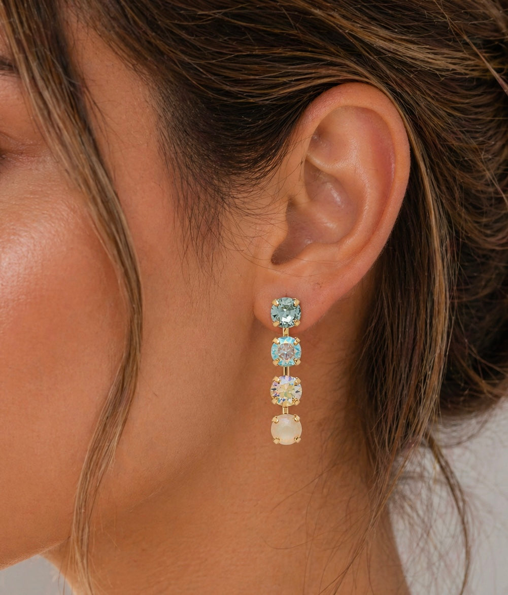 Sorrelli Matilda dangle earrings featuring intricate designs and sparkling gemstones, hanging from silver hooks.