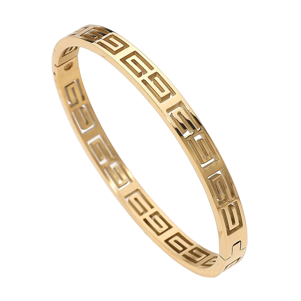 Gold bracelet with geometric pattern on a light gray background