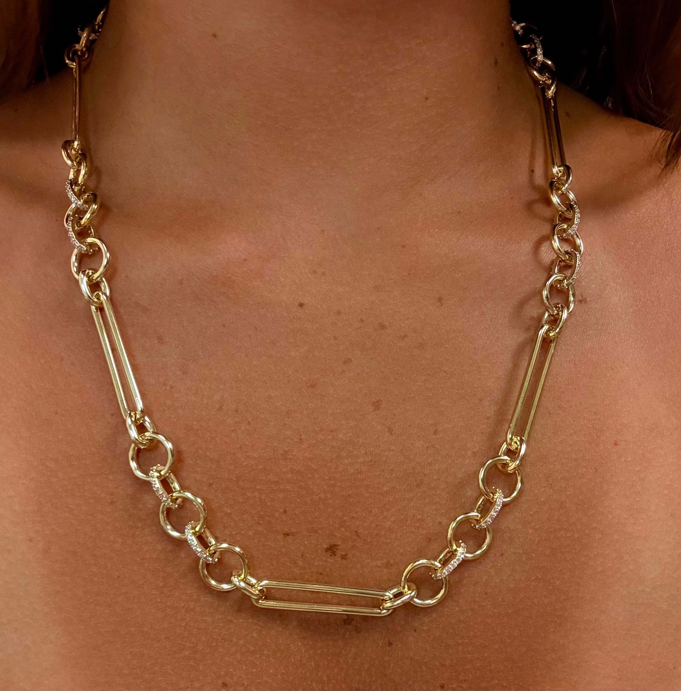 Gold chain necklace on a person's neck