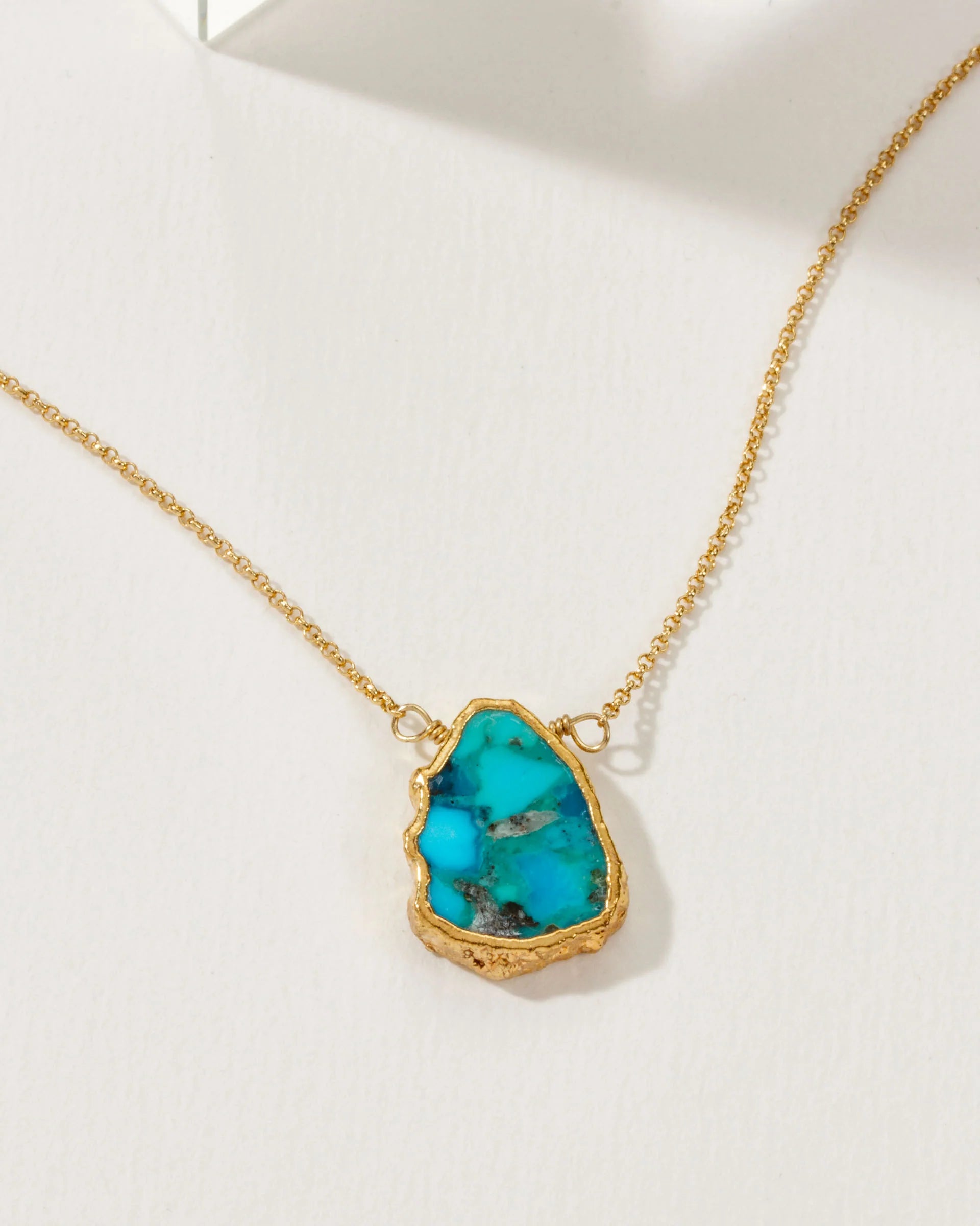 Luna Norte Earth, Wind and Fire genuine stone turquoise necklace with gold chain, featuring vibrant turquoise stones and intricate design.