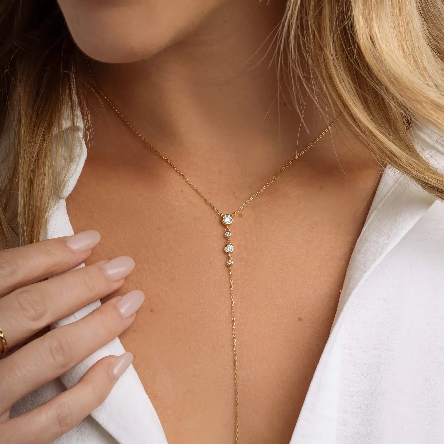 Gold bezel lariat necklace with delicate chain and pendant, stylish jewelry piece from Private Vendor.