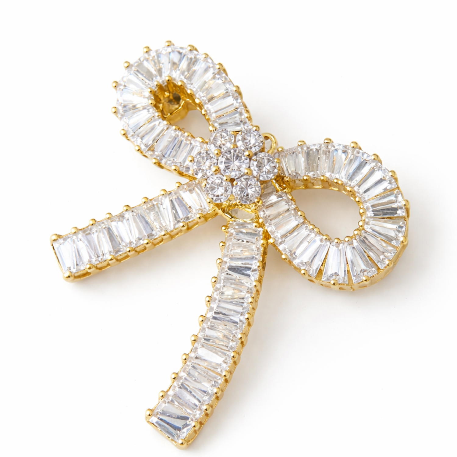 Elegant crystal ribbon bow brooch from Private Label featuring sparkling crystals and a classic pin-back design.