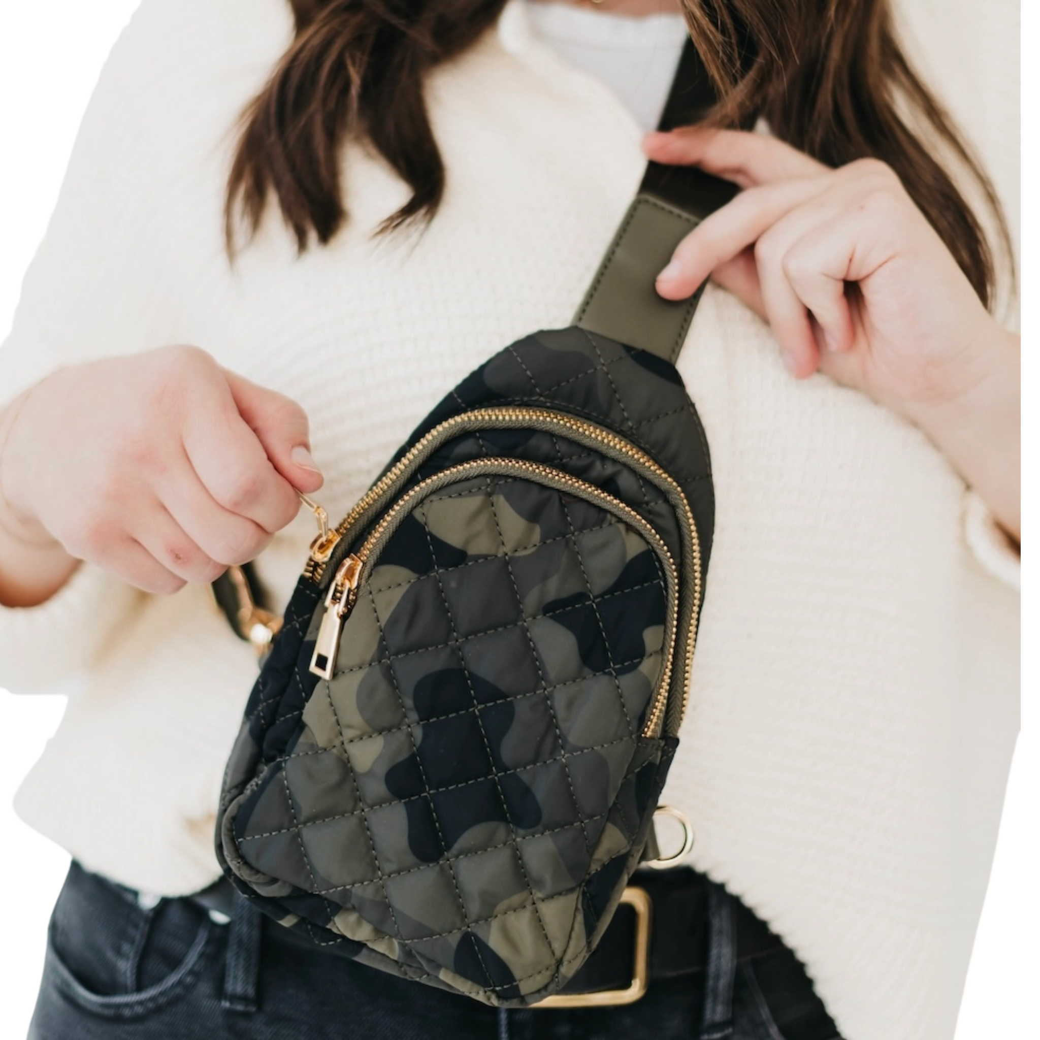 Person holding a black quilted bag with gold zippers