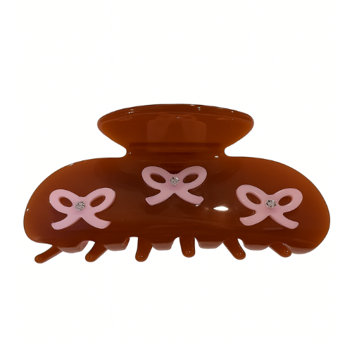 Brown hair claw clip with pink bows on a white background