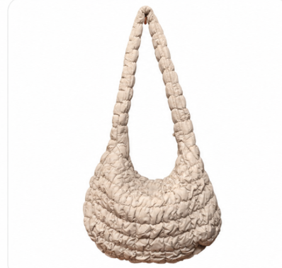 XL quilted puffer crossbody handbag by private label with padded, textured design and adjustable strap for casual style.