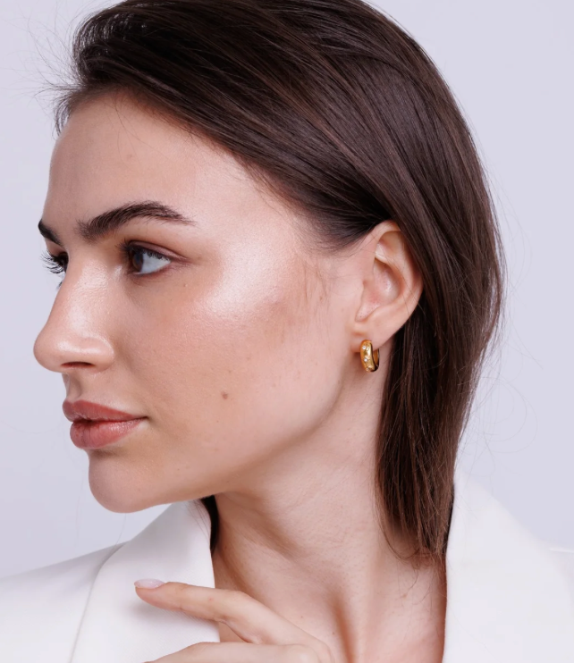 Chubby hoop earrings featuring an evil eye design with CZ stones in 18K gold, waterproof PVD finish.