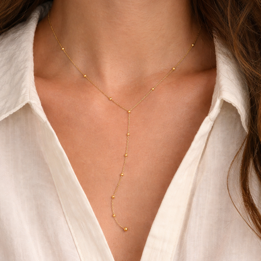 Brisse 18K gold non-tarnish beaded Y lariat necklace with elegant design and shimmering beads.