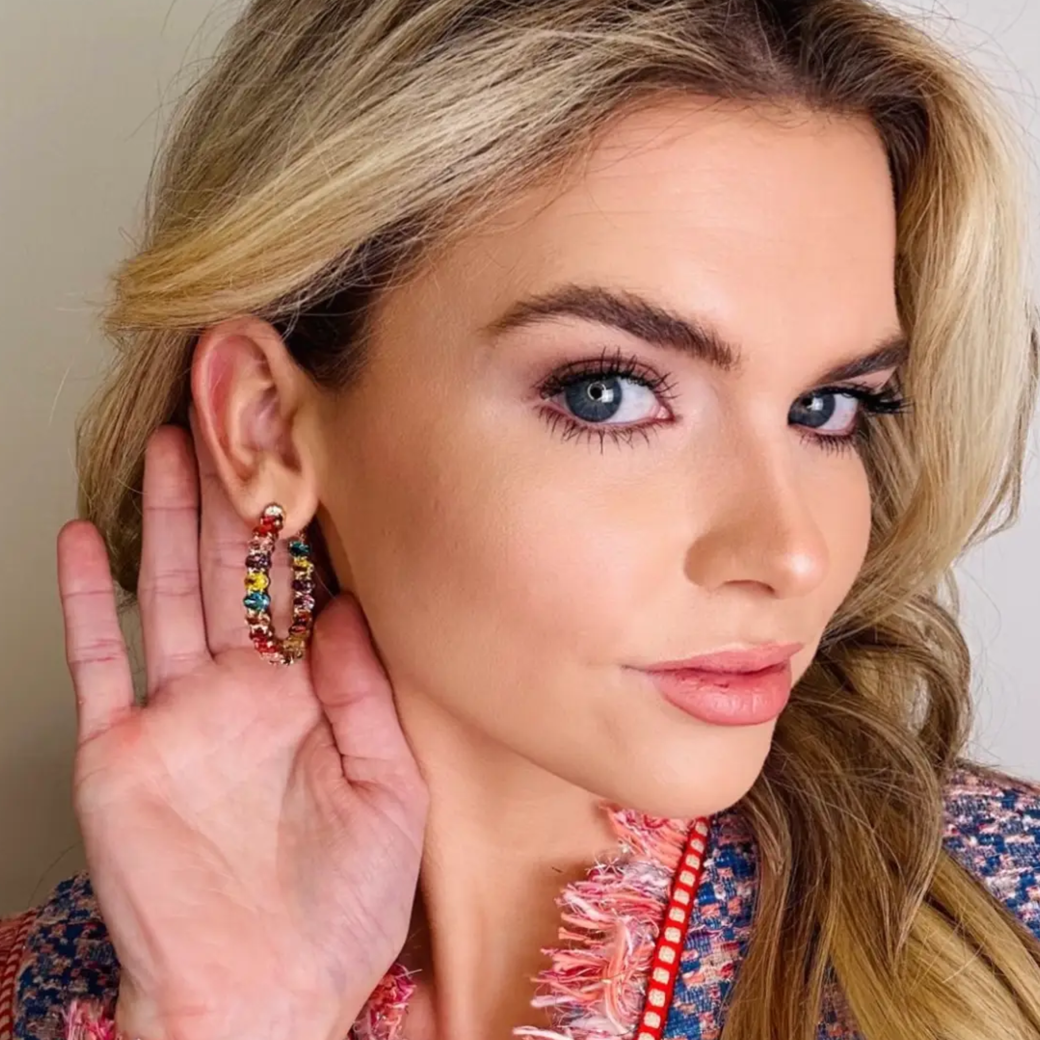 Colorful Sadie jeweled hoop earrings by Private Label, showcasing multicolor gemstones and shimmering gold hoops.