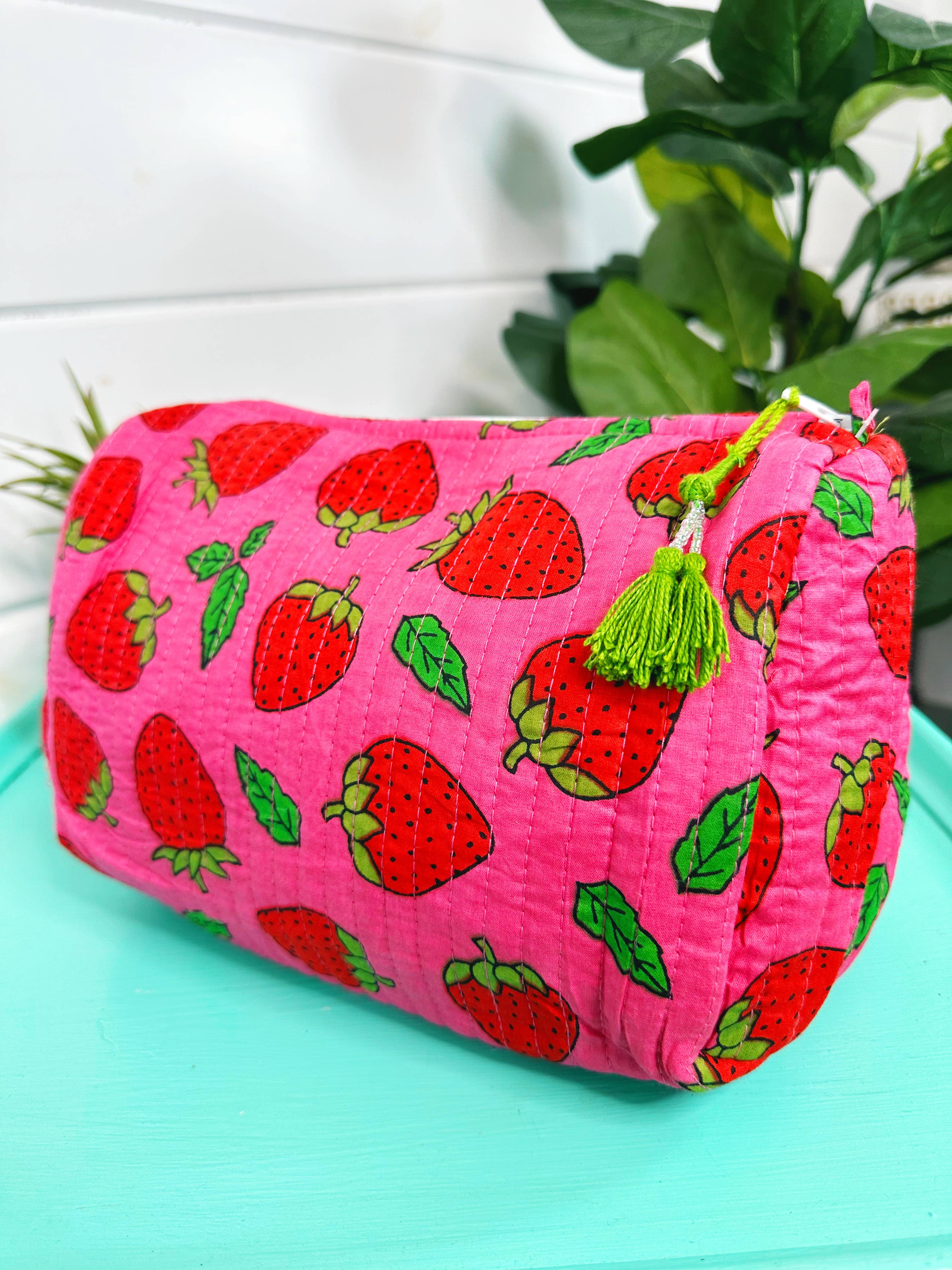 Quilted strawberry makeup bag by Folklore Couture, featuring a stylish design and ample space for cosmetics.
