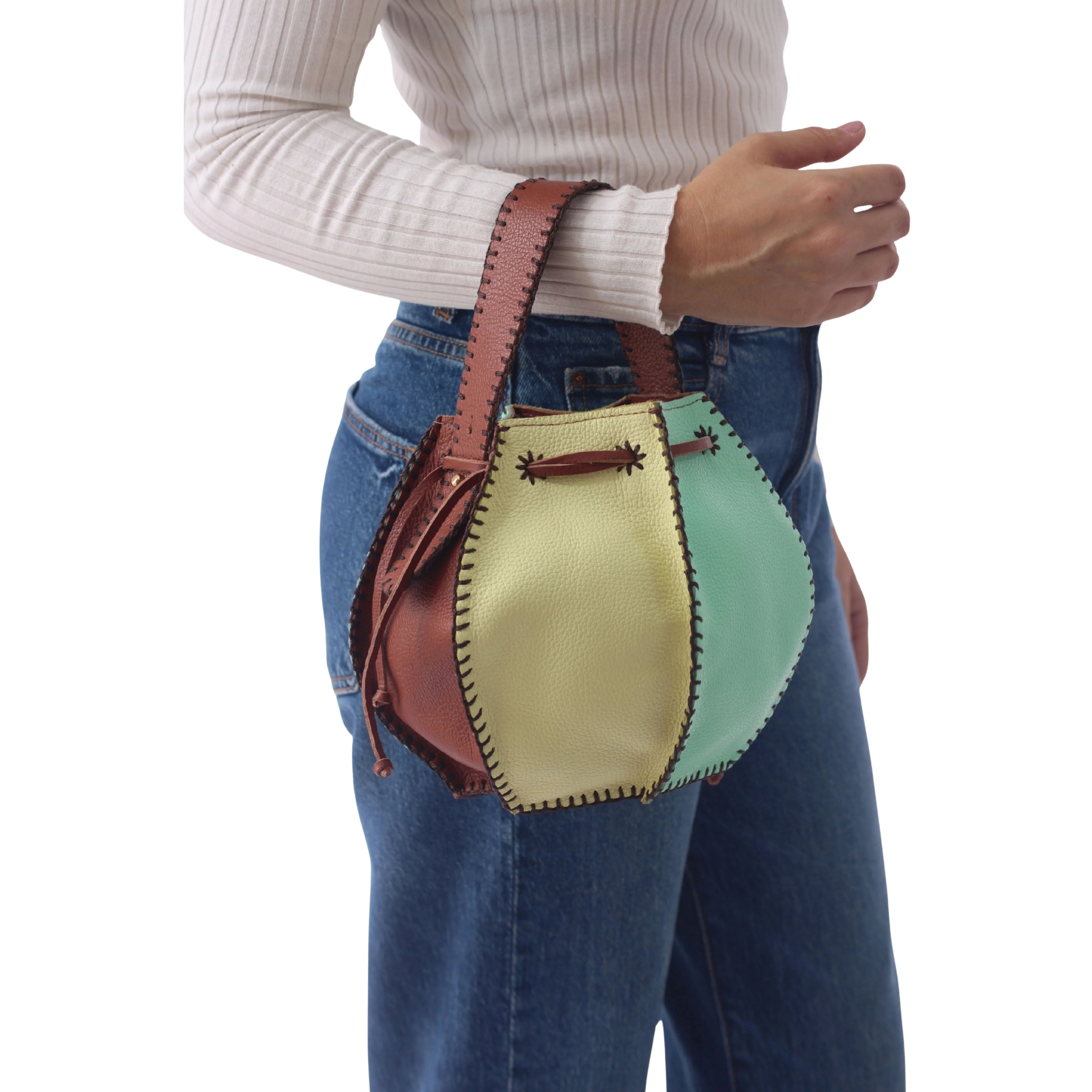 Yellow lemon-shaped tall bucket bag by Carlos Falchi with a textured surface and sturdy handle.