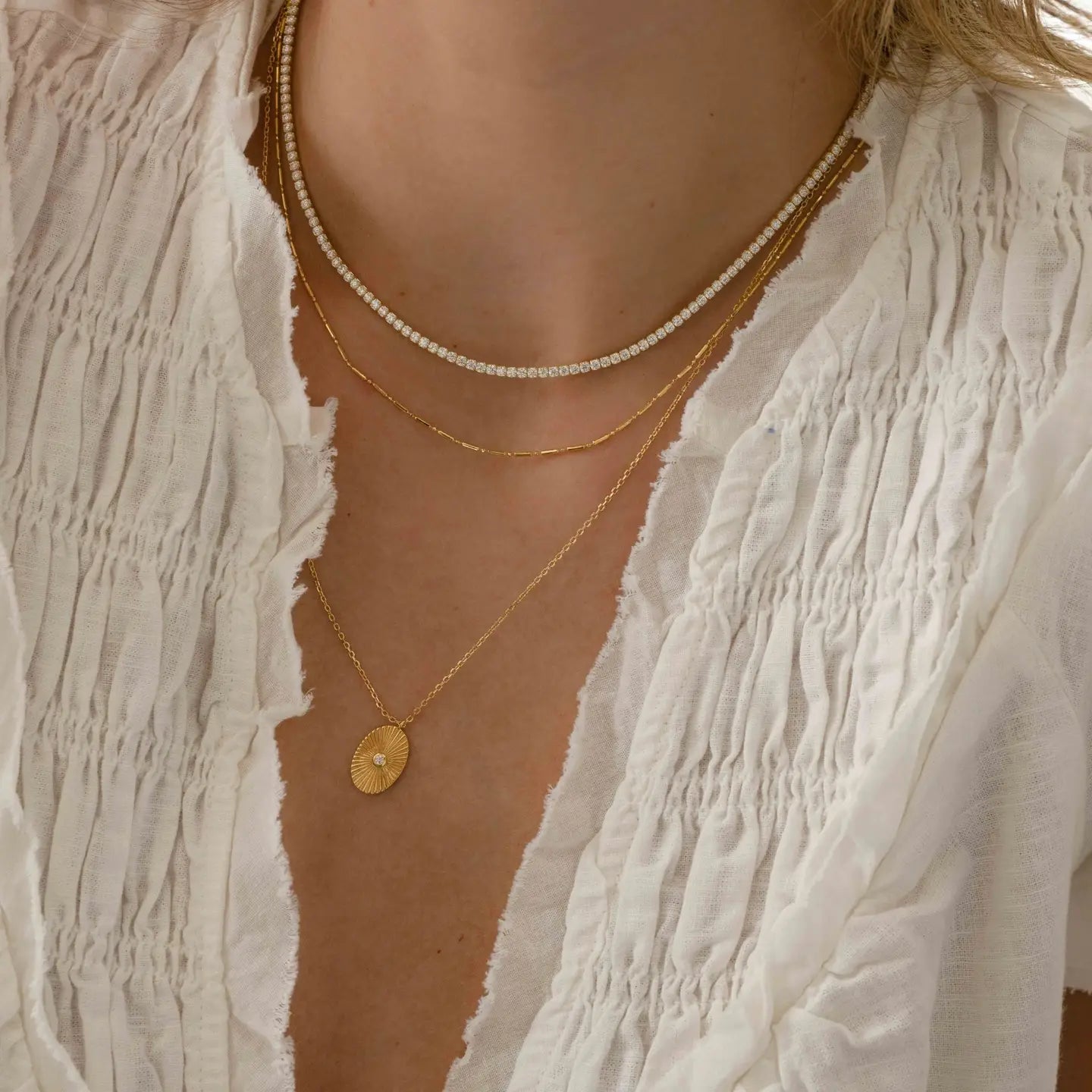 Close-up of a 2mm Private Label Tennis Necklace showcasing its sleek, sparkling chain design on a neutral background.