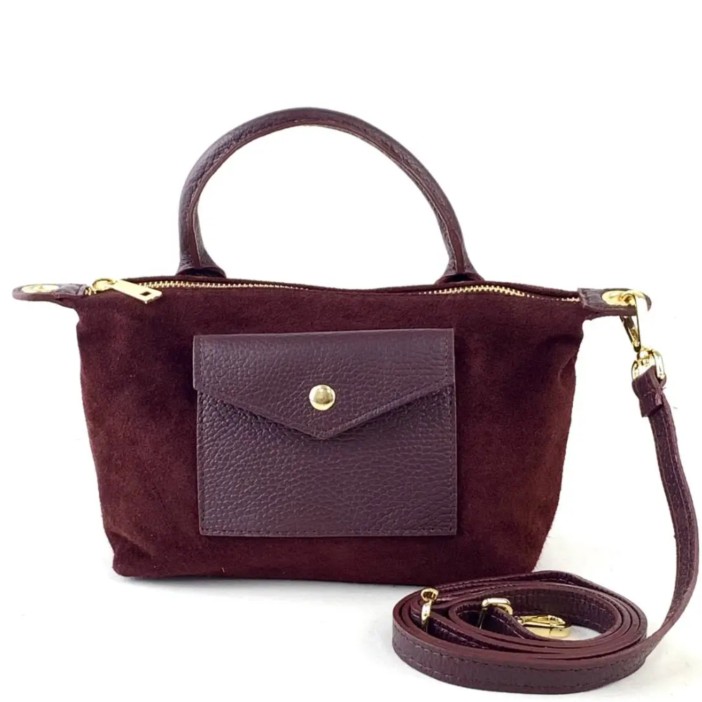 suede mini crossbody with a gold zipper and strap on a white background