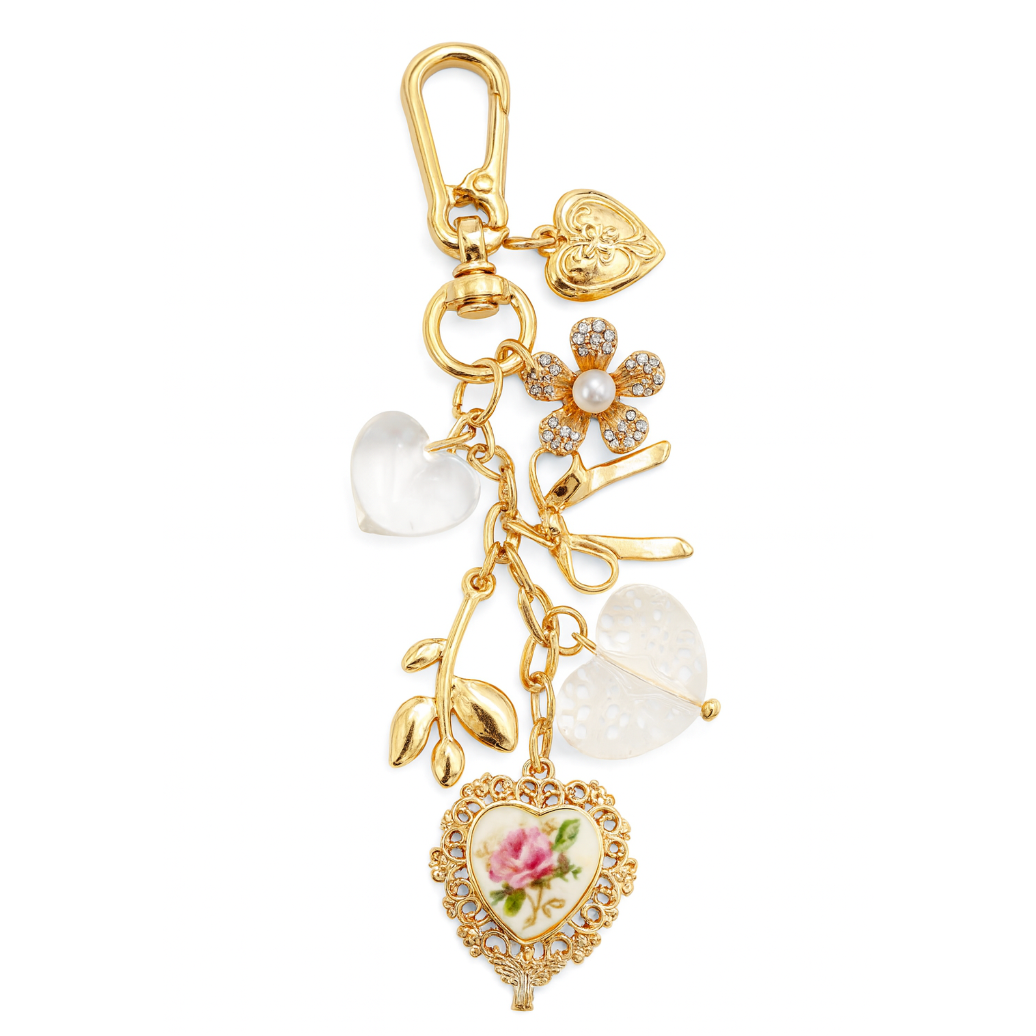 Gold charm with floral heart design, pearls, and other embellishments on a white background